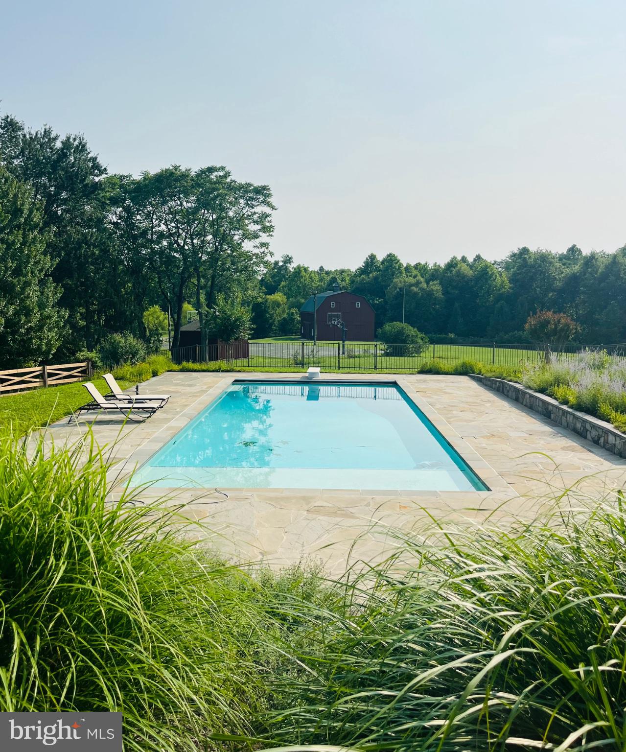 Coming Soon! More details and professional photos coming! Amazing oasis just outside of Poolesville, MD in the heart of the Agricultural Reserve. Bucolic views abound from every window of this custom home featuring over 7000 square feet of finished living space, HUGE inground swimming pool and flagstone patio surround, rear deck, full front porch, outdoor basketball/tennis court with lights, two-story board and batten barn with finished upper-level doubles as storage and entertainment space (indoor basketball/sport court ready!) all situated on over 12 acres within mere minutes of downtown Poolesville and top-rated Poolesville High School! Prime location, freshly painted throughout, refinished hardwoods throughout, professionally landscaped. A MUST SEE!