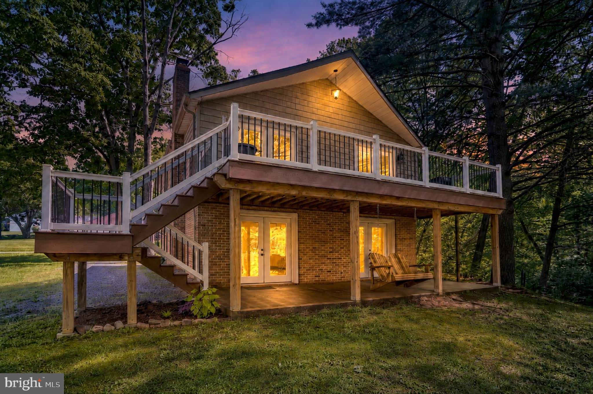 Tucked away on a private, end-of-street lot right on Lake Strauss, 156 Lakeside Drive is a peaceful 3-bedroom, 2-bathroom retreat where you can truly slow down, enjoy the water, and spot everything from passing deer and turkeys to herons and hawks. The main level welcomes you with a bright, open-concept layout featuring dramatic vaulted ceilings, a cozy fireplace, and a functional kitchen island built for bringing people together. Right off the living area, a large deck offers beautiful water views and a front-row seat to this absolute birdwatcher’s paradise—it's the perfect spot to unwind and watch the turtles, ducks, and geese on the lake. Downstairs, a newly fully finished basement serves as a complete secondary living quarters or guest suite, beautifully equipped with a bedroom, full bath, its own fireplace, and a convenient kitchenette. Complete with access to the community kayak dock, this home is about more than just square footage—it’s a place for a family to feel grounded. If you're ready for a home that feels like a calm, quiet escape from the noise, we’d love to help you take that next step.