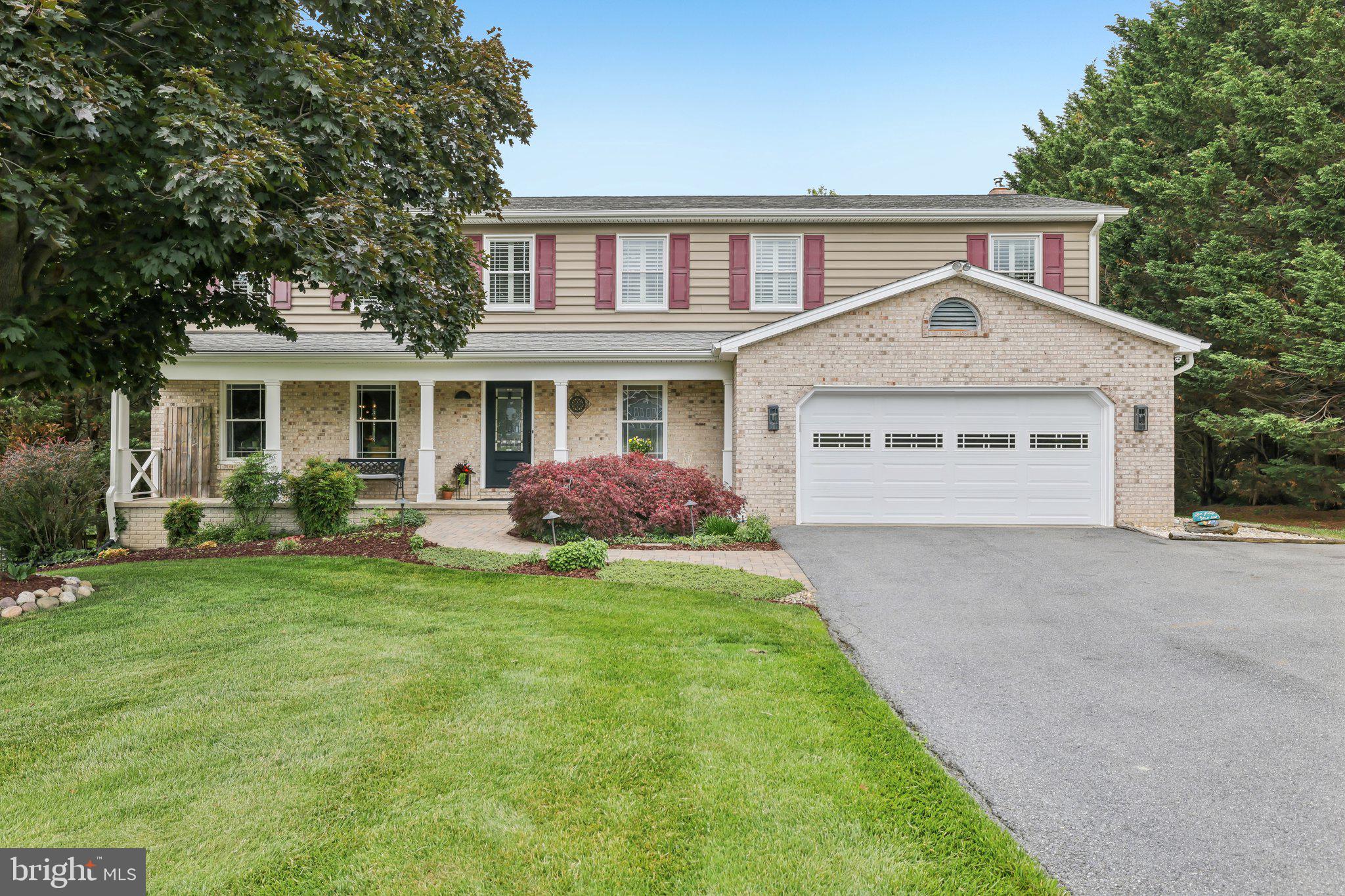 Beautifully maintained and thoughtfully updated home offering expansive living spaces, refined finishes, and exceptional indoor-outdoor entertaining on a picturesque, park-like lot. Rich engineered hardwood flooring, plantation shutters, neutral designer tones, and updated lighting create a warm, polished feel throughout. Spacious main living areas flow effortlessly for everyday comfort and entertaining alike. The kitchen features granite countertops, abundant cabinetry, tiled backsplash, breakfast bar seating, and an open dining area overlooking the beautifully landscaped backyard. The inviting family room with pellet stove provides a cozy gathering space, while the formal living room and dining room offers added living space for entertaining and gatherings. The spacious primary suite serves as a true retreat with upgraded flooring, custom barn-style door, and a beautifully renovated spa-inspired bath featuring dual vanities, heated tile floors, an oversized walk-in glass shower, and a freestanding soaking tub. Generously sized secondary bedrooms on the upper level and updated baths continue the home’s move-in ready appeal. The finished lower level dramatically expands the home’s functionality with an oversized recreation area, custom live-edge wet bar, media/lounge space, and flexible areas ideal for entertaining, hobbies, fitness, or guests. Outdoor living is truly exceptional with an elevated deck, expansive paver patio, built-in fire pit seating area, mature landscaping, and sweeping lawn framed by towering trees for added privacy and beauty. Whether hosting gatherings or enjoying a quiet evening outdoors, this nearly one-acre backyard delivers the perfect setting. Combining generous space, quality updates, and outstanding entertaining areas inside and out, this home offers comfort, style, and versatility throughout.
