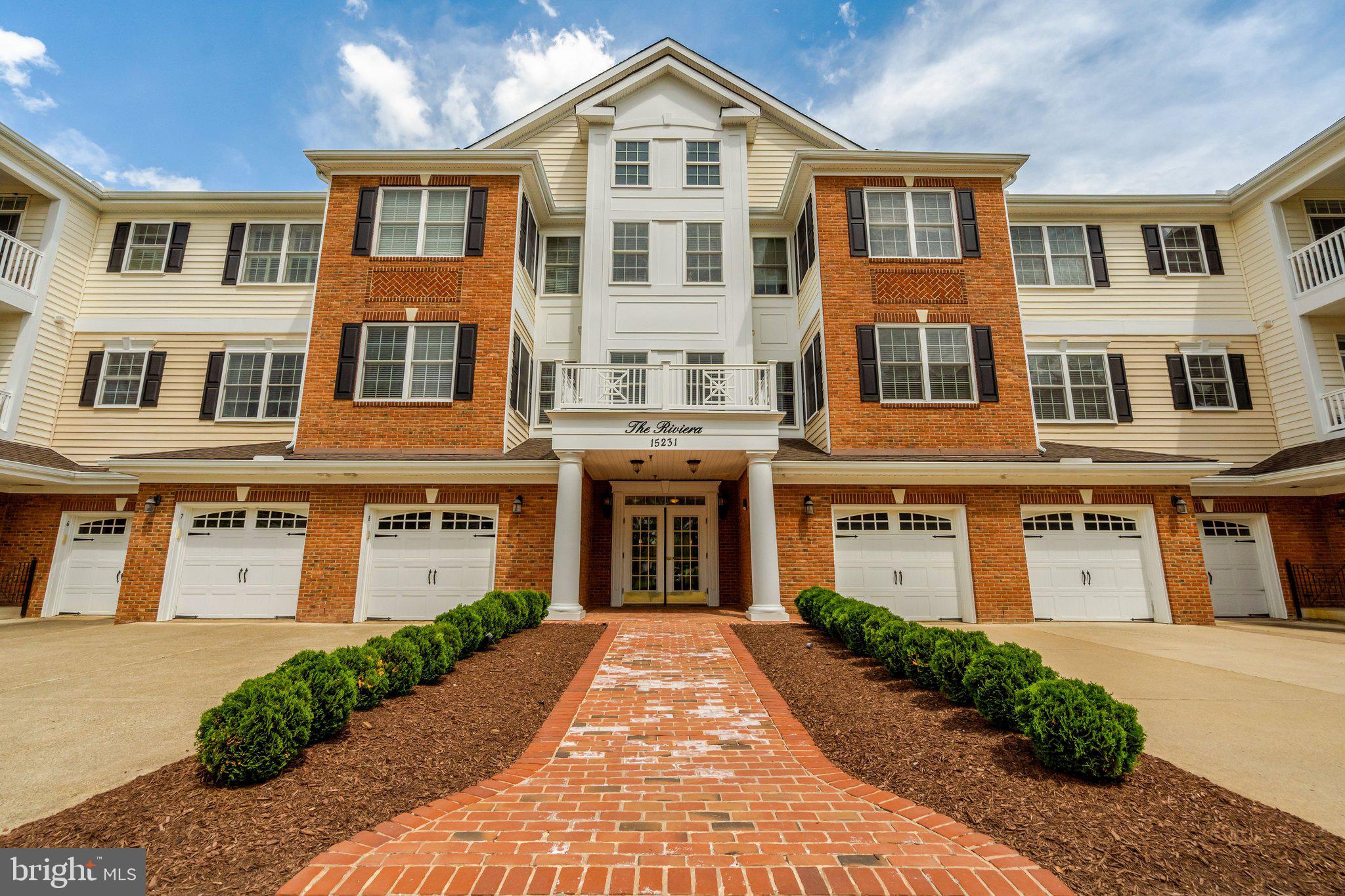 Welcome to the prestigious and amenity filled community of The Regency at Dominion Valley. This premiere 55 and over community offers exceptional amenities including indoor and outdoor pools, a fully equipped fitness center, an 18 hole Arnold Palmer signature golf course, clubhouse, and on-site restaurant - perfect for both active lifestyles and leisurely enjoyment.  Trails throughout the neighborhood provide beautiful views of nature and waterways, as well as quick access to grocery shopping, restaurants, nail & hair salons and more.  You can enjoy serene sun-filled living in this beautifully maintained condominium, ideally situated on the 2nd floor with convenient elevator access.  The covered east facing balcony overlooks lush trees and green space in a protected wooded preserve with active stream offering peaceful views, privacy, and the occasional exciting glimpse of local wildlife such as deer, squirrels, and plethora of song and hummingbirds - it's the perfect place to start your morning with a cup of coffee or to wind down in the evening.  Inside, medium hued hardwood floors set the tone for the warmth that exudes in this property.  The wood floors flow through the main living areas and hallways, complementing the plushly carpeted bedrooms. The primary suite features generous walk in closets, en suite bathroom, and sitting area.  The primary bathroom boasts a luxurious soaking tub, dual sinks, and large shower with bench seat.  The secondary bedroom and extra full bath provides comfort and privacy for guests and other occupants .  The kitchen is a chef's delight with light cream cabinetry, granite countertops, stainless steel appliances, and cozy breakfast area.  The bar height countertop is also perfect for casual eating.   The separate formal dining room is able to accommodate multiple people for meals.  The spacious living room opens to the balcony and creates the perfect spaces for either entertaining or relaxing. In-unit laundry with full size washer and dryer adds everyday convenience. Additional perks include the attached, heated in-building garage space that fits one car and concrete driveway that fits an additional car.  Guest or overflow parking is conveniently located in front of the building and throughout the community.  Easy access to the garage using the elevator or stairs, great for staying dry on rainy days.  This beautiful condo combines comfort, style, and resort style living in one of the area's most desirable communities.