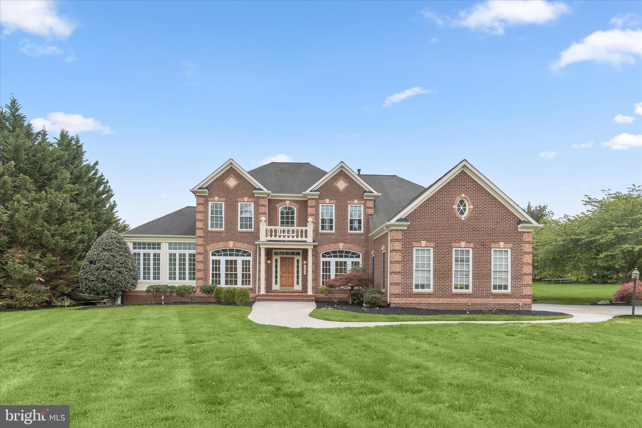 Spacious colonial set on a premium 2.26-acre lot in a sought-after Sykesville community, offering over 4,000 square feet of beautifully appointed living space. A stately all-brick front and grand two-story foyer welcome you inside, where rich hardwood flooring flows throughout the main level. Formal living and dining rooms are enhanced by elegant accent molding and framed by architectural columns. Just beyond, a bright and airy sunroom showcases panoramic views of the serene property.  The expansive chef’s kitchen is designed for both everyday living and entertaining, featuring an island breakfast bar, granite countertops, stainless steel appliances, and a sun-filled breakfast room. The kitchen opens seamlessly to the inviting family room anchored by a striking stone fireplace. Glass French doors lead to a private home office, while a powder room and a well-appointed laundry room with garage access complete the main level. Step outside to the expansive deck, offering scenic open views of the beautifully landscaped 2.26 acres, perfect for relaxing or entertaining while enjoying the peaceful surroundings.  Upstairs, the luxurious primary suite offers a peaceful retreat with a sitting room, spacious walk-in closet, and an elegant en suite bath boasting dual granite vanities, a soaking tub, and separate shower. Three additional generously sized bedrooms and a hall bath complete the upper level.  The walkout lower level has already been framed for future rooms and awaits your customization to suit your exact needs. Ideally located with convenient access to major commuter routes, as well as shopping, dining, and entertainment, this exceptional home combines space, comfort, and opportunity in a prime setting.  (Some photos have been virtually staged)