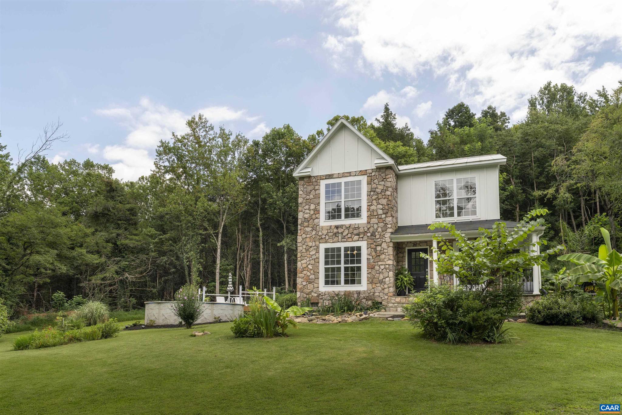 Private Sanctuary on 15+ Acres in Western Albemarle, offered for the first time. This meticulously maintained home is set on over 15 acres under conservation easement, with neighboring properties also protected, ensuring complete privacy and no future development. Located just 5 minutes from downtown Crozet and 20 minutes to Charlottesville, it offers the perfect blend of seclusion and convenience. Enjoy mountain views and a beautifully landscaped setting designed to be your personal oasis. The home features over $266,000 in upgrades, including a new addition, low-maintenance metal roof, new carpet and LVP flooring, a private pool with new decking, and new kitchen granite surfaces. The exterior boasts durable HardiePlank board and batten siding with stone veneer accents. Inside you?ll find two upgraded walk-in showers and custom built-in cabinetry in the primary suite.  Every detail has been thoughtfully updated to enhance both comfort and style. Don't miss your opportunity to own a unique, private, protected retreat in sought-after Western Albemarle.,Granite Counter,White Cabinets,Fireplace in Family Room,Fireplace in Living Room
