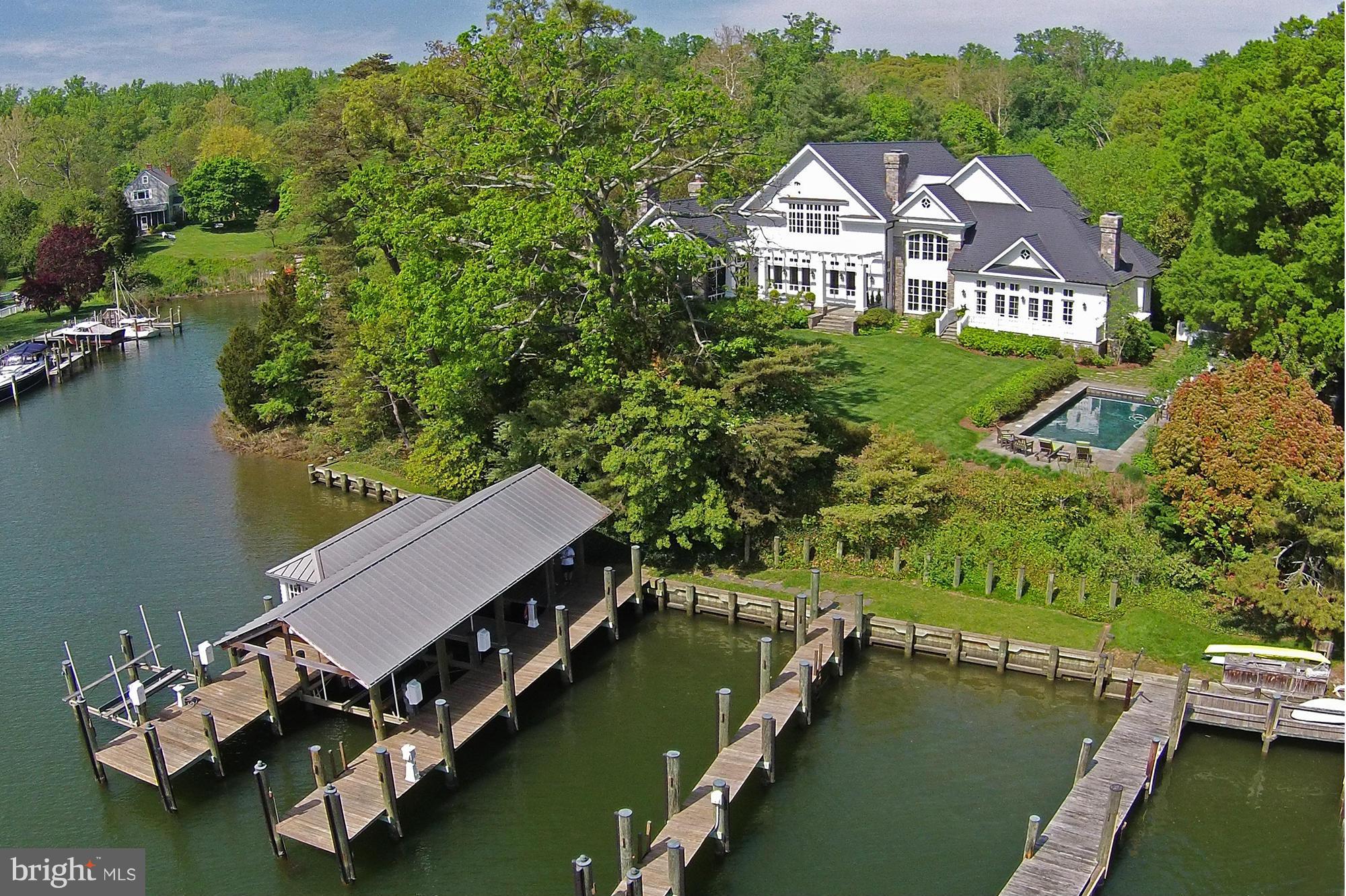 Private tree lined driveway,canopied with silver maples, leads to this exceptional Waterfront Manor Home built in 2002 with fine materials &  detailing on 7.9 acres.  Elegant & welcoming interior w/ 5 en suite BRs. Protected deepwater piers w/ boathouse & 3 slips on Little Aberdeen Creek. Waterside pool, ample acreage for horses & a 3 stall barn overlooking fenced pastures.
