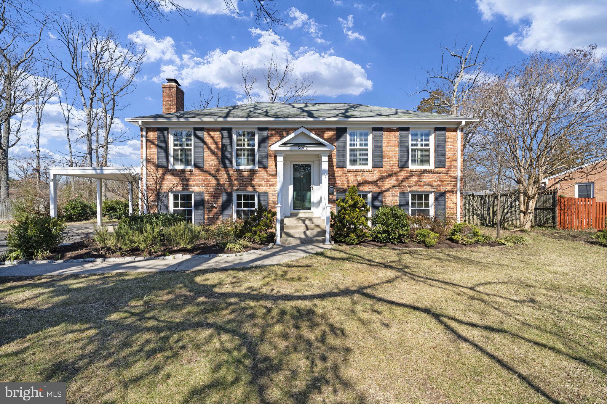 This charming brick home sited on a large .28 acre lot, offers stately curb appeal in a popular neighborhood. The main level features an open-concept dining and living area, highlighted by elegant crown molding and plantation shutters. Hardwood floors throughout most of the main level enhance the home's warmth and character. The well-appointed kitchen boasts beautiful wood cabinets, a subway tile backsplash and a window over the sink, making it both functional and relaxing.  Two spacious bedrooms and a full bathroom complete the main level. The lower level is designed for relaxation and entertainment with a cozy family room featuring a brick fireplace. Two additional bedrooms and another full bathroom provide ample space for family or guests. There is a large storage and laundry area for added convenience. The property includes a large deck, perfect for grilling and entertaining, and a beautifully landscaped backyard.  An attached carport and large driveway provide for easy in and out.