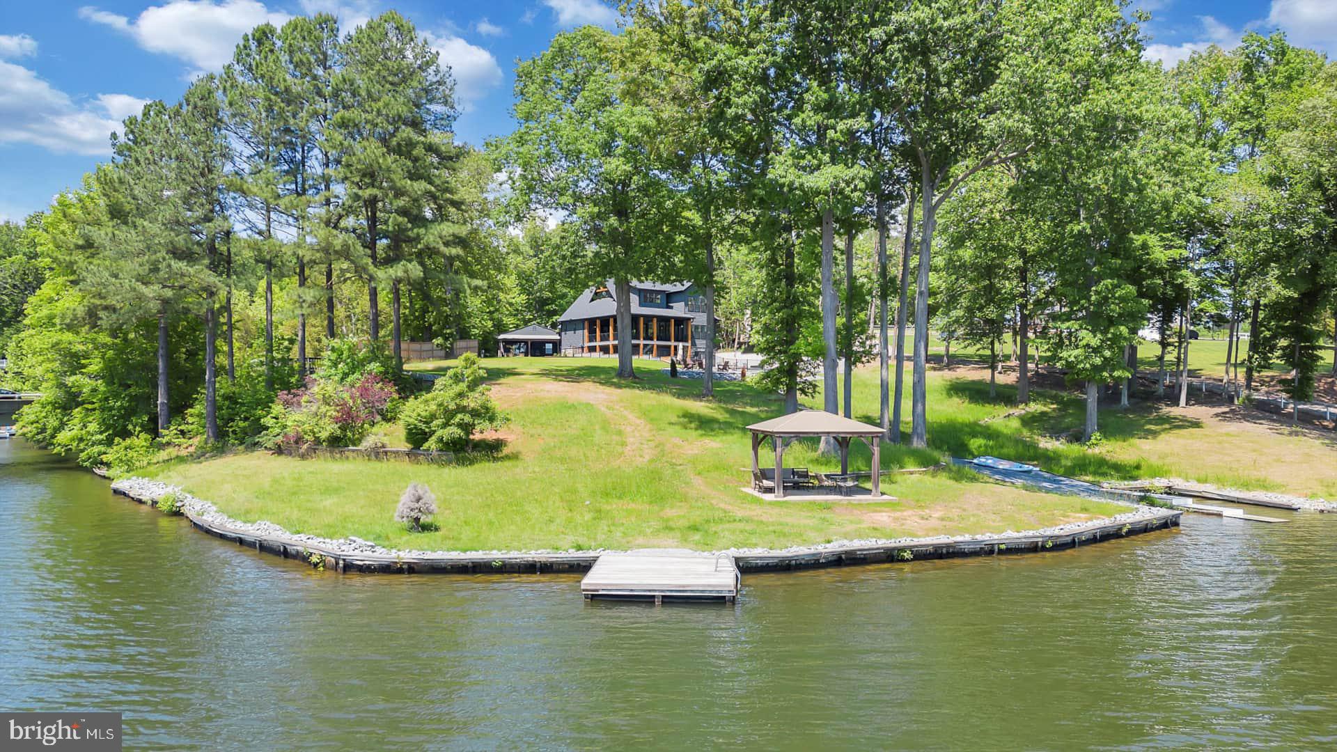 Unparalleled luxury lake home with a priceless view! This stunning custom home boasts 10 bedrooms, 7 bathrooms, an in ground infinity pool, hot tub, large lakefront yard and more!  Perfectly perched overlooking beautiful Lake Anna, this gorgeous home features a main 7-bedroom home and 3-bedroom guest cottage along with a private in ground salt water heated POOL with waterfall overflow and Hot Springs 8-person HOT TUB. The home comes fully loaded with a large pool deck veranda overlooking the lake along with a fire pit, PRIVATE DOCK and luxury living with a spacious, open vaulted floor plan with large covered decks and windows overlooking the lakefront providing abundant natural light and views.  Over 400 ft of bulkheaded waterfront, a swim platform, ramp for kayaks/canoes, boat slip and a beautiful lakeside gazebo perfect for morning coffee or evening dinners. Deep water for swimming! NO HOA! Easy water access to Lake Anna restaurants and marinas - conveniently located to local shopping, sights, and more.  Currently a very successful short term rental property, managed by Lake Anna Property Management & Real Estate.  Nearly $250k in rental income for 2024 after a late start to the season as construction completed in June.  Approximately $400k in current bookings for 2025.
 Let's get you home...to Lake Anna!