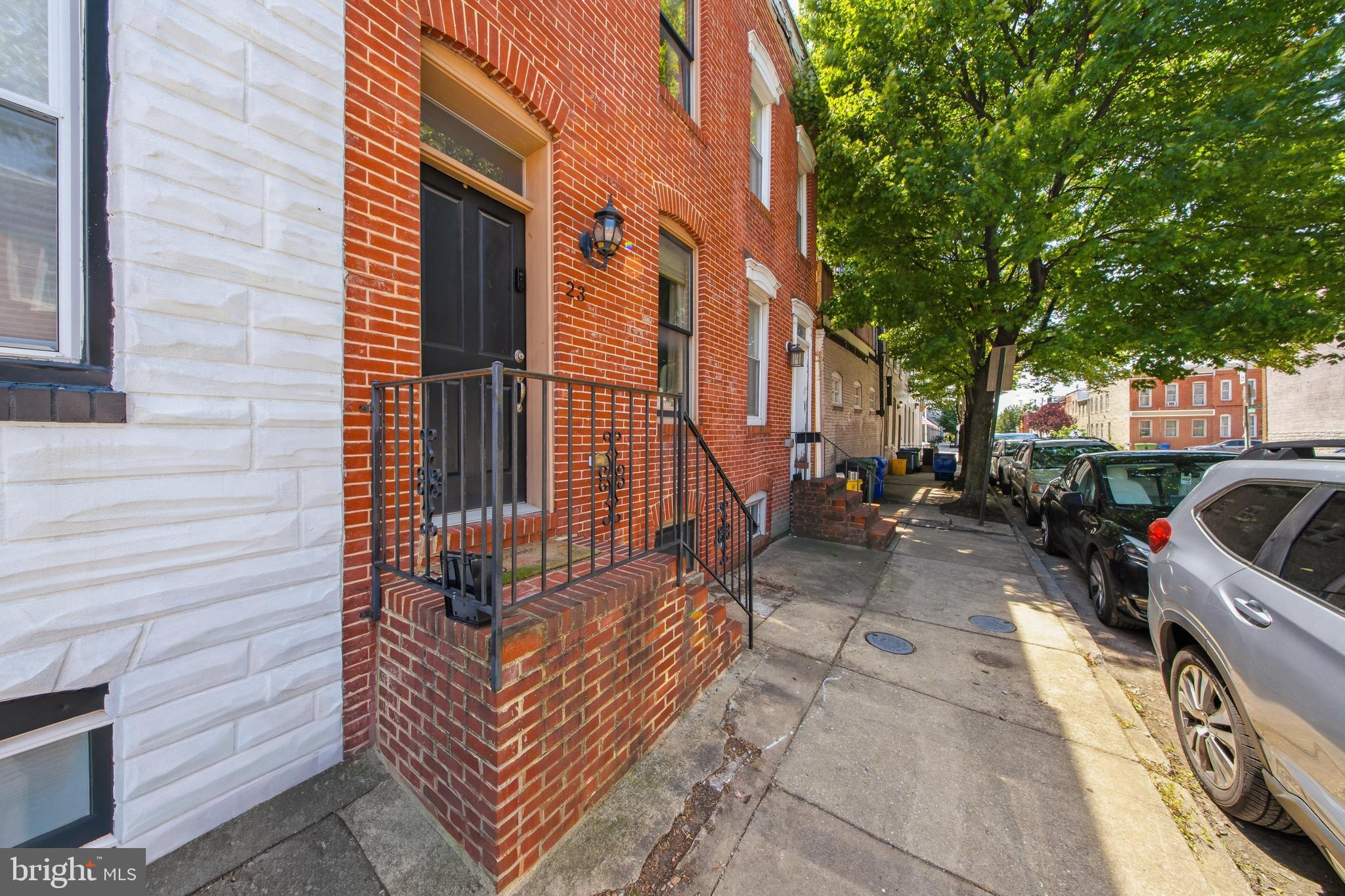 Thoughtfully updated while preserving its timeless Federal Hill character, this classic brick row home offers the perfect blend of historic charm and modern comfort. Featuring 2 bedrooms, 2 full bathrooms, a main-level powder room, a finished lower level, and a rooftop deck the home provides flexible living space in one of Baltimore's desirable neighborhoods.
The open-concept main level welcomes you with beautiful hardwood floors, exposed brick, and abundant natural light. The spacious living and dining areas flow seamlessly into the updated kitchen, complete with white cabinetry, granite countertops, stainless steel appliances, a gas range, breakfast bar, and a custom built-in dining room cabinet that adds both character and functionality.
Upstairs, hardwood floors continue throughout both bedrooms. . The generously sized primary suite features custom closet systems and a sun-filled layout, while the en suite bath includes a jetted soaking tub (all new subflooring and tiles). The second bedroom offers two spacious closets, its own private en suite bathroom, and charming French doors that open to a balcony.
A staircase leads to the rooftop deck—an ideal spot to unwind, entertain, or enjoy views of the surrounding neighborhood. The newly carpeted finished lower level provides valuable bonus space perfect for a home office, media room, home gym, or guest retreat.
Recent improvements provide added peace of mind, including a new AC system and smart thermostat (2025), complete replacement of the exterior BGE electrical wiring (2026), recently re-tarred roof ( Dec 2023), replaced cornice (Dec 2025) and new back door steps and railing (2026).
Situated on a quiet one-way street, this home offers the best of Federal Hill living. Enjoy an easy walk to Riverside Park, Camden Yards, M&T Bank Stadium, neighborhood restaurants, shops, and local favorites, while commuters will appreciate the quick access to I-95 and downtown Baltimore.