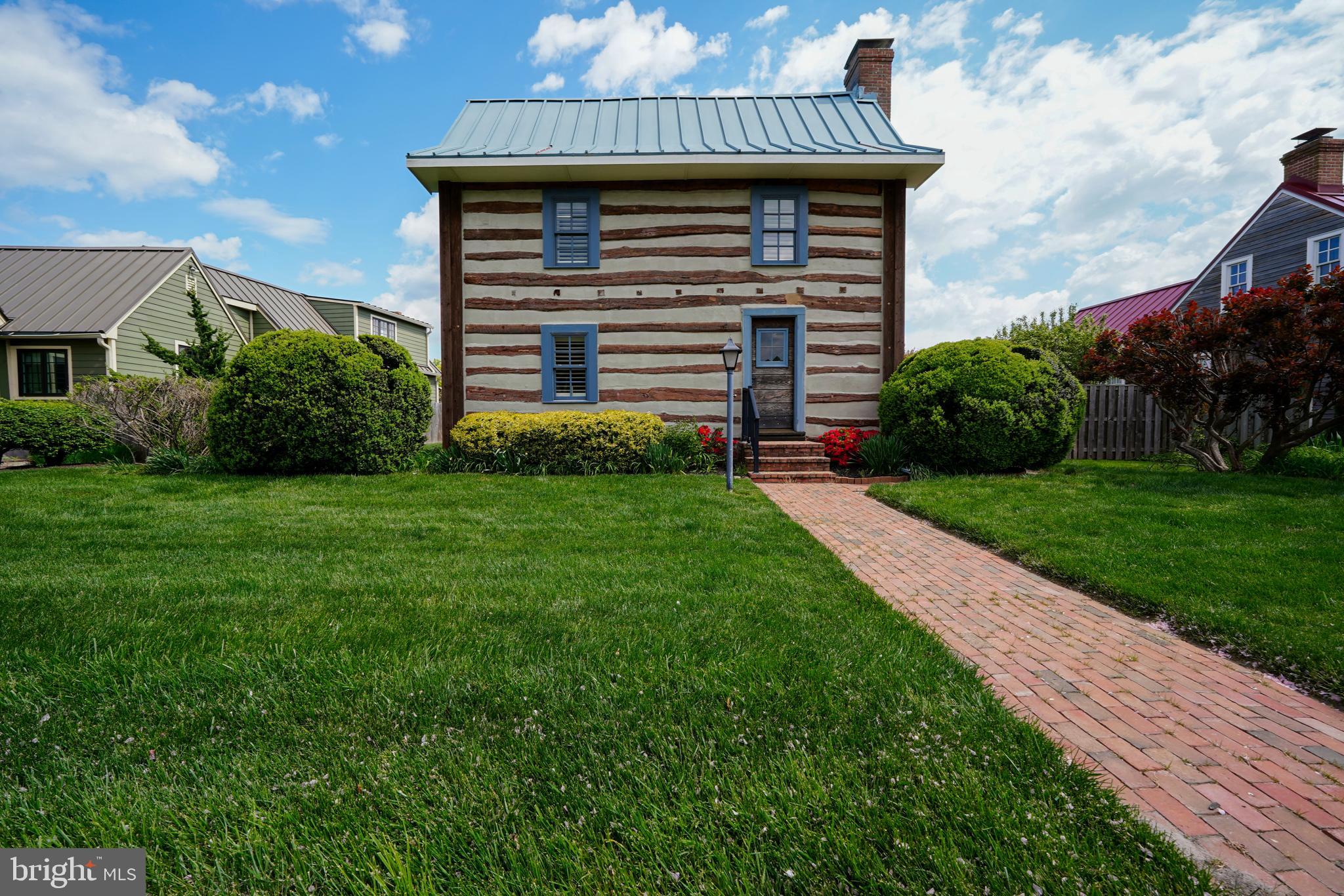 ONCE-IN-A-GENERATION OPPORTUNITY IN HISTORIC SHIPCARPENTER SQUARE

Rare opportunity to own a beautifully restored historic log cabin in the heart of Shipcarpenter Square, one of Lewes' most distinctive and sought-after neighborhoods. Designed to reflect the charm and character of Delaware's architectural heritage, Shipcarpenter Square is centered around a picturesque village green and offers a setting unlike anything else at the Delaware beaches.

Steeped in history, this remarkable two-story log home was originally built circa 1795 in Frederick, Maryland, and is representative of the log cabins constructed by German and Scotch-Irish settlers throughout the Mid-Atlantic region in the late 18th and early 19th centuries. In 1988, the cabin was carefully relocated to Shipcarpenter Square, where each hand-hewn log was meticulously tagged and reconstructed in its original position, preserving the authenticity of the home. Visible throughout the interior are original axe and hatchet marks from its 18th-century construction, offering a rare glimpse into early American craftsmanship. As was customary for the period, the cabin was constructed without nails; instead, the hand-hewn logs are secured through expertly crafted notched joints, stacked and fitted together using traditional building techniques.

Ideally located just a short walk from downtown Lewes, Canalfront Park, restaurants, boutiques, the marina, and Lewes Beach—and only a bike ride from Cape Henlopen State Park—this property seamlessly blends historic character with modern convenience.

Thoughtfully restored and reimagined for today's lifestyle, the home features refinished hardwood floors, remodeled bathrooms, and a custom kitchen complete with handcrafted cabinetry, quartzite countertops, stainless steel appliances, under-cabinet lighting, and a whole-house water filtration system. A carefully designed addition expanded the living space, creating a welcoming entry and family room while preserving the home's timeless appeal. Additional highlights include custom built-ins and closets, barn-style doors, new windows in the addition and kitchen, and recently updated HVAC systems that enhance year-round comfort and functionality.

This is more than a home—it's a rare opportunity to own a piece of early American history in one of Lewes' most beloved communities.