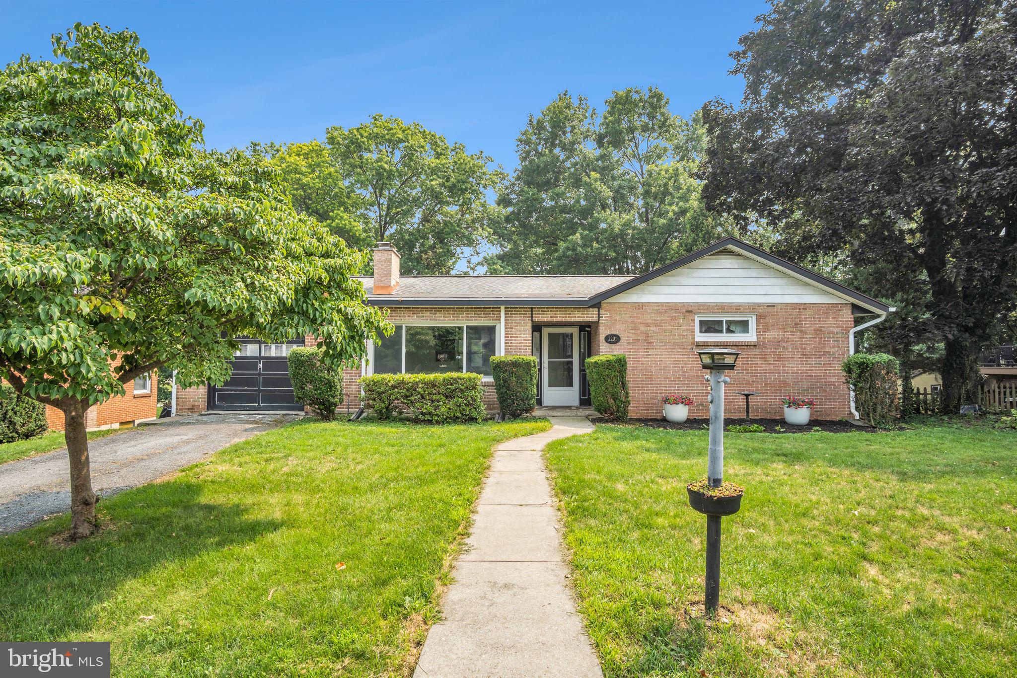 Welcome to 2201 Logan Street in the heart of Camp Hill Borough—a beautifully maintained brick ranch offering the perfect blend of timeless character, generous living space, and an unbeatable location.

This spacious home features 4 bedrooms and 3 full bathrooms, with a thoughtfully designed floor plan that provides comfortable one-floor living while offering additional finished space in the lower level. The bright and inviting main level showcases a large living room with a fireplace, an expansive kitchen with abundant cabinetry and a breakfast area, and spacious bedrooms filled with natural light.

The finished walk-out lower level significantly expands your living options with a large family room, second fireplace, additional bedroom and full bath, plus flexible space that's ideal for guests, a home office, in-law quarters, or multi-generational living. Step outside to the private patio and enjoy the beautifully landscaped backyard—perfect for entertaining, relaxing, or enjoying peaceful evenings.

Additional highlights include energy-efficient geothermal heating, ample storage throughout, an attached garage, and mature landscaping that enhances the home's curb appeal.

Located within the desirable Camp Hill School District, you'll love being just minutes from local parks, schools, shopping, dining, and major commuter routes while enjoying the charm and walkability of Camp Hill Borough.

Don't miss this rare opportunity to own a spacious ranch with versatile living space in one of Central Pennsylvania's most sought-after neighborhoods. Schedule your private showing today!