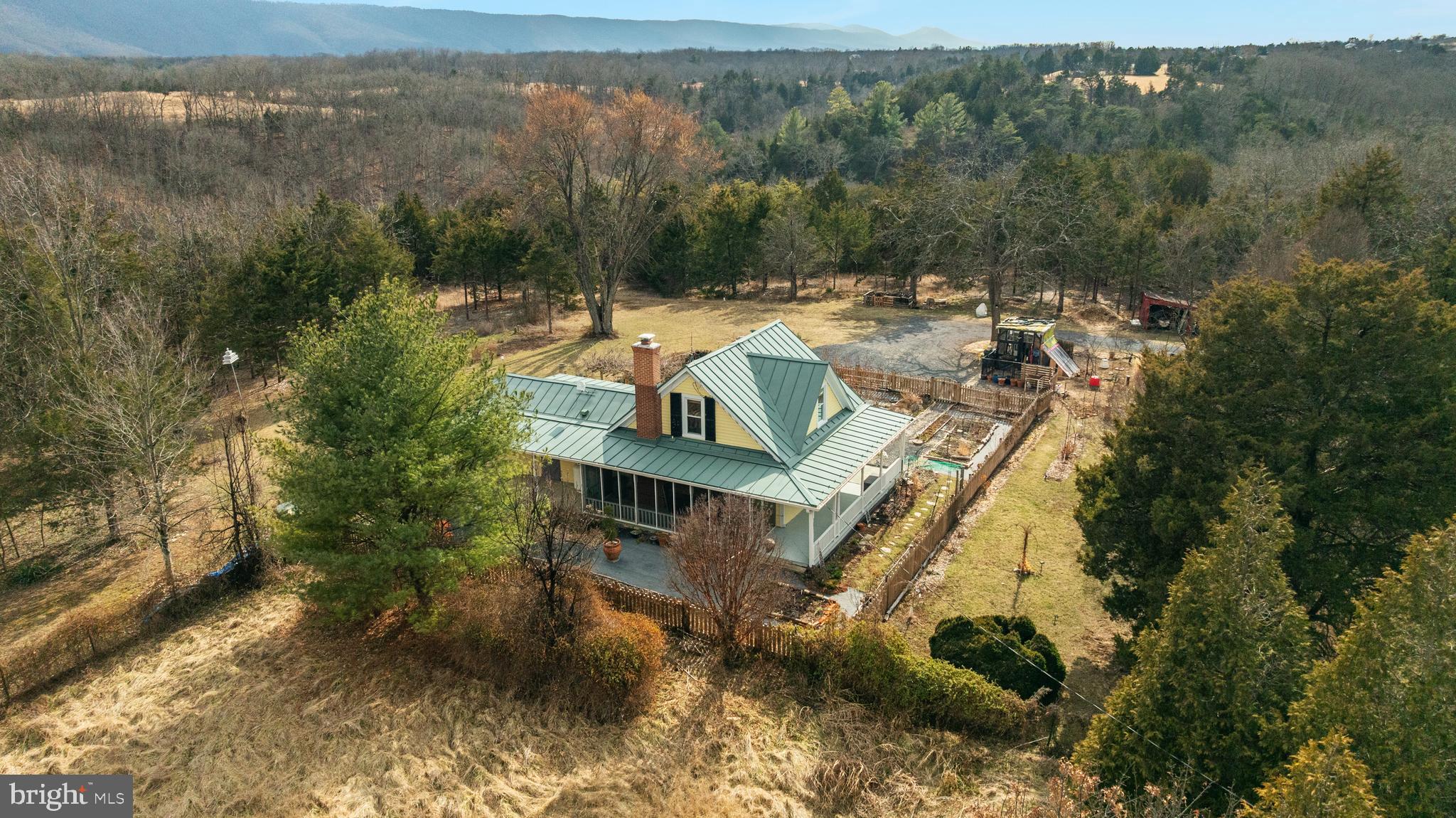Welcome to the Fisher's Hill area of Strasburg, VA! This charming 1940s farmhouse offers the best of country living on 9 private acres with stunning Shenandoah Valley mountain views and a hidden private driveway off Route 11. Step inside to find beautiful hardwood floors and natural light throughout, with remote control skylights bringing the outdoors in. The property is fully self-sufficient with a private well, dual upstairs and downstairs HVAC systems, and two propane tanks that convey. Outside you'll find a productive and established landscape with peach, walnut, fig, persimmon, and pear trees, perennials for all seasons, a fenced kitchen garden, and a fenced paddock. Multiple outbuildings offer storage, workshop, or hobby space. Surrounded by cedar trees and adjacent to conservation land, the setting offers genuine privacy and peace. Recent updates include a new standing seam metal roof (2024), gutters (2024), dual HVAC systems (2024), and septic upgrades (2026). Septic, radon, and pest inspections have been completed. Reliable rural internet available. Easy commuter access to I-81 and I-66.