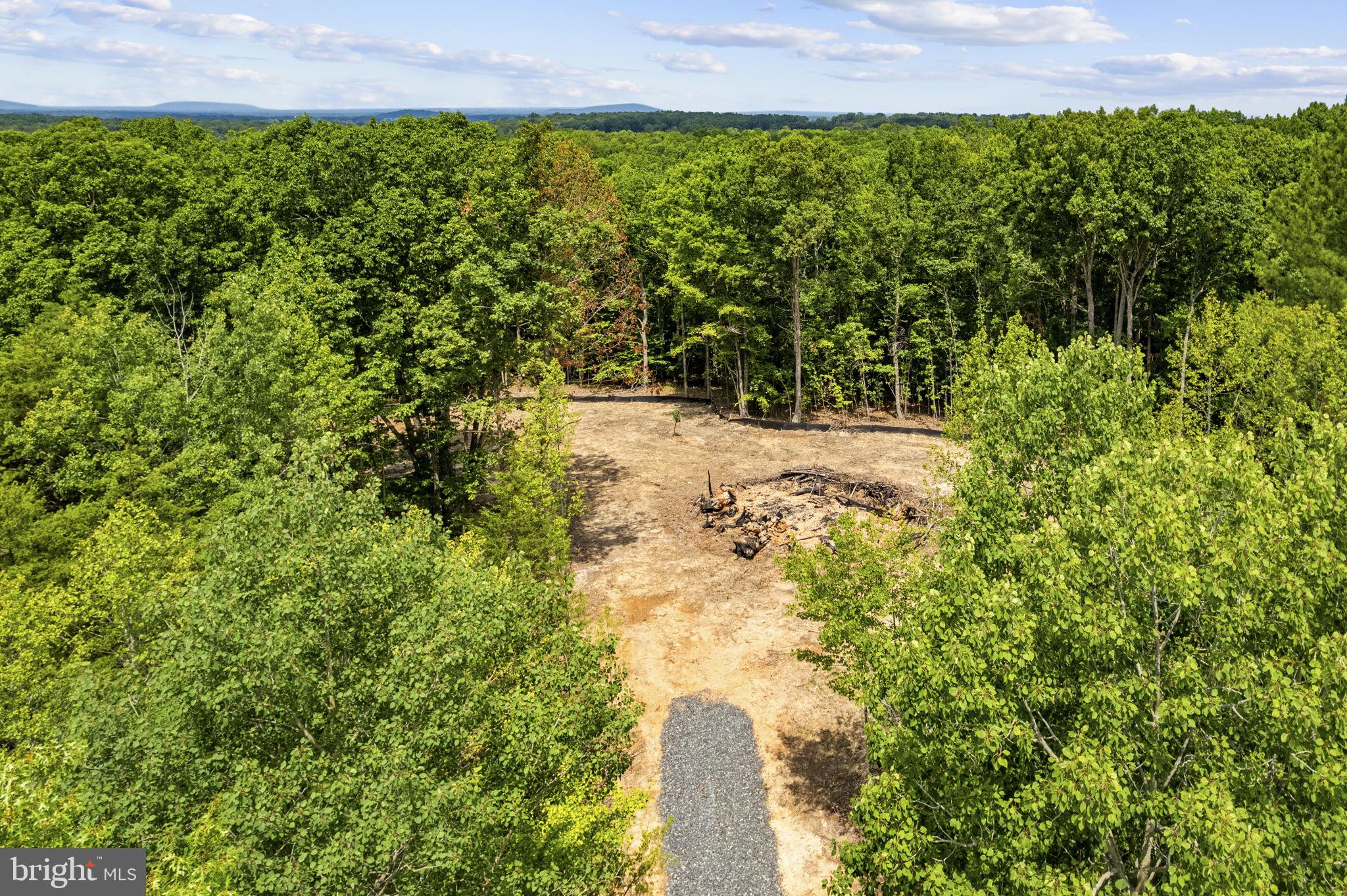 Verizon FIOS available! Private three acre lot with recent survey, conventional perc, drainfield/well site is designed and the health department application is ready to be submitted. This property is conveniently located about five minutes from Rt 3, far enough away to enjoy peace and quiet. Approximately a 7 minute drive to the Locust Grove Walmart, 17 minutes to the town of Culpeper, only about 30 minutes into Fredericksburg. This property is far enough away to be the sanctuary you have dreamed of, but close enough to still have easy access to “all the nice things.” 
In the district for Pearl Sample Elementary, Floyd T Binns Middle, and Eastern View High School. There is a waste transfer station, free to Culpeper residents, only about 5 mintues away. The property is wooded with tall pines near the state road that quickly transitions to a typical Virginia hardwood forest. This lot is fully accessible from blacktop pavement, clearing the lot and REC electric hook-up fees are included in the asking price! This is a “shovel ready” opportunity to bring that “forever home” to life. Land sale is subject to a pre construction contract with Inspired Home Building, Realtor notes contain the details. There are light covenants posted to the Realtor Docs, but there is no HOA. Typical build time from permitting is 8-10 months until move-in. Inspired Home Building has a "move-in ready" model home available about 5 minutes away to assist with selections, etc., as well.