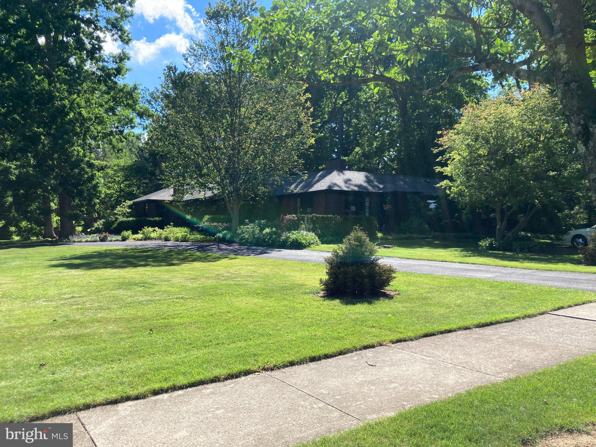 This is a one-of-a-kind opportunity: spacious and charming ranch house on a full one acre lot in the Borough of State College! Experience the convenience of one floor living in an historic home with a contemporary flair. Features include a large, updated kitchen, modern bathrooms, and an open concept floor plan. Hardwood floors are throughout the entire main level with tile in the baths. In the living room you'll find a lovely wood-burning fireplace and plenty of built-in shelves. The family room, just off the kitchen, is a plant-lover's dream with skylights and floor to ceiling windows overlooking the backyard deck. The primary suite has two closets (one is a walk-in) and the other two bedrooms are large as well. There are closets galore, including a walk-in cedar closet ( 6 x 8) and two linen closets. Thoughtfully designed nooks and crannies are built into many spaces. The spacious basement is accessed by two stairways on opposite sides of the house. There is a finished family room here with another fireplace, and the unfinished space includes a workshop, and a gym area (the gym mats stay). There are outdoor spaces to enjoy as well. Sit and watch the world go by on your large, covered front porch. Or entertain friends and have a barbecue on your private back deck. Do you have pets? A portion of the backyard is fenced for their enjoyment. Stately hardwood trees and gardens surround the home on all sides - truly a little slice of paradise here in the heart of the Borough, with easy access to schools, shopping, and campus.
