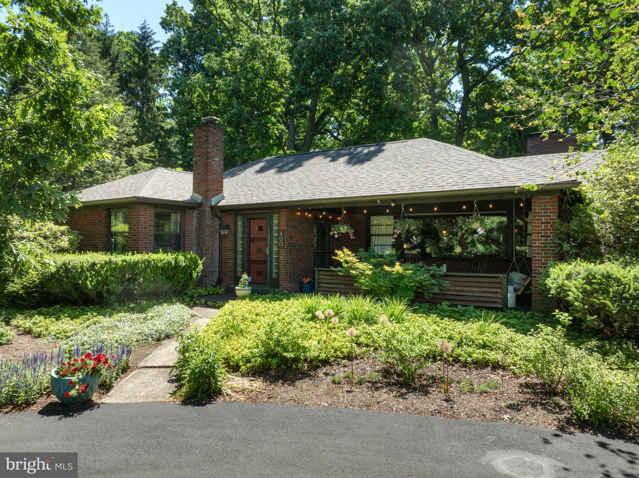 This is a one-of-a-kind opportunity: spacious and charming ranch house on a full one acre lot in the Borough of State College! Experience the convenience of one floor living in an historic home with a contemporary flair. Features include a large, updated kitchen, modern bathrooms, and an open concept floor plan. Hardwood floors are throughout the entire main level with tile in the baths. In the living room you'll find a lovely wood-burning fireplace and plenty of built-in shelves. The family room, just off the kitchen, is a plant-lover's dream with skylights and floor to ceiling windows overlooking the backyard deck. The primary suite has two closets (one is a walk-in) and the other two bedrooms are large as well. There are closets galore, including a walk-in cedar closet ( 6 x 8) and two linen closets. Thoughtfully designed nooks and crannies are built into many spaces. The spacious basement is accessed by two stairways on opposite sides of the house. There is a finished family room here with another fireplace, and the unfinished space includes a workshop, and a gym area (the gym mats stay). There are outdoor spaces to enjoy as well. Sit and watch the world go by on your large, covered front porch. Or entertain friends and have a barbecue on your private back deck. Do you have pets? A portion of the backyard is fenced for their enjoyment. Stately hardwood trees and gardens surround the home on all sides - truly a little slice of paradise here in the heart of the Borough, with easy access to schools, shopping, and campus.