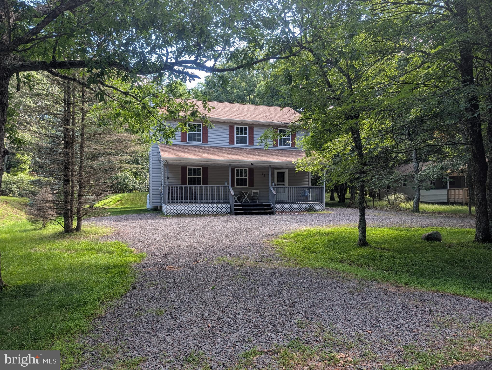 Welcome to the neighborhood that's always on vacation! Whether you're searching for a full-time residence, vacation getaway, or short-term rental investment, this home offers an affordable opportunity in amenity-filled Towamensing Trails.

Set on a private lot with a U-shaped driveway, the home features a covered front porch, inviting living room with a gas fireplace, open dining and kitchen area, first-floor laundry, and a powder room. Upstairs you'll find three bedrooms and a full bath with access from both the hallway and the primary bedroom. The wooded backyard offers a fire pit, grassy area, and storage shed.

Towamensing Trails is one of the few communities in the area that allows short-term rentals while offering exceptional amenities, including a 190-acre lake with a beach, in-ground pool, lakefront restaurant and snack bar, tennis and basketball courts, boat rentals, walking trails, fishing, and a brand-new playground. Explore it all by golf cart!

Conveniently located near the PA Turnpike (I-476), Jim Thorpe, Hickory Run State Park, and the area's top ski resorts, water parks, and outdoor attractions, this home is perfectly positioned to enjoy everything the Poconos has to offer.