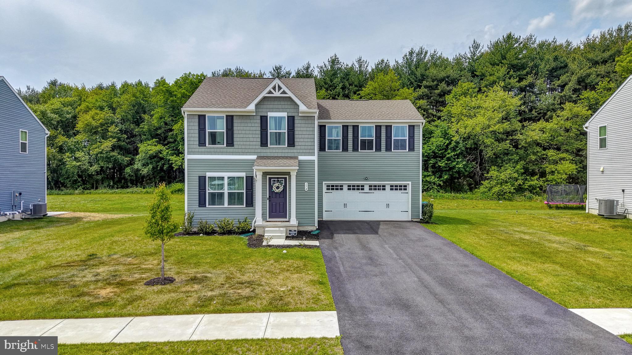 Welcome to 174 Quartz Drive in the desirable Stonington community. This well-maintained two-story home offers 4 bedrooms, and 2.5 bathrooms. The main level features an open-concept layout with a spacious kitchen, dining area, and living room. The kitchen includes dark cabinetry, stainless steel appliances, a center island, modern countertops, recessed lighting, and a stylish backsplash. Upstairs, the primary suite offers a walk-in closet and private full bath, while three additional bedrooms, a full hall bath, and laundry provide convenience and flexibility. Outside, enjoy a two-car garage, paved driveway, and a backyard that backs to mature trees for added privacy. Located in Stonington, this home offers space, style, and functionality, along with the convenience of living just minutes from Routes 1 and 13, making commuting, shopping, dining, and everyday travel easy.