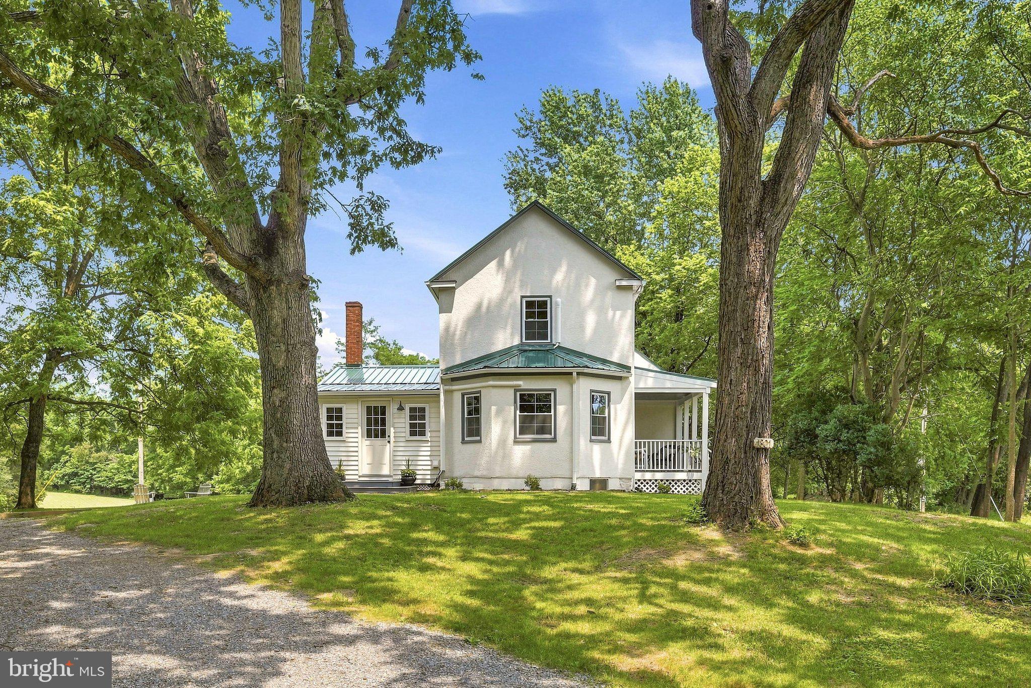 Come over The Blue Ridge Mountains into The Shenandoah Valley.  As you do, you will begin to feel a sense of calm and peace.  As you drive down Old Chapel Road, a scenic and historical byway, you will  see mountain vistas and rolling famland surrounding you. Gracefully Nestled on a knoll, you'll pull into the circular driveway to this Circa 1900s classic stucco farm house. The 4.2 acres tht surround it are lush green rolling fields with Aisles of ancient trees running through it. It's perfect for horses, cows, goats, a small fruit orchard, grape vines and more. There are no retrictions here. Chickens are also welcome. 
   Step up on to the front porch that has plenty of room for gatherings and your favorite rocking chairs.  The front door is vintage with the original doorknob to match it. The owners have done everything to weave together the old and the new in a way that compliment each other, The freshly sanded pine and oak floors run through out the home. There's a turned elegant staircase, 6" base molding and the original doors and knobs are still intact. On the main level, there are 9 ft. ceilings and a traditional floorplan. All of the rooms are a good size with plenty of room to show off all of your favorite things. This special home has 3 bedrooms. One is on the main level with easy access to the full bath. 
   The list of renovations is extensive and completed with quality in mind. 2026 was the year to breath  new life back into this classic home. There is a new metal roof, they last a long time, new windows in the style of the home, gutters,  mini-splits for heating and cooling, freshly sanded floors and new vinyl ones. All of the old plaster walls have been re-worked by a master at the craft.. There is all fresh interior painting, brand new plumbing throughout, all new bathroom fixtures, light fixtures and much electrical work completed. You can just move in and begin enjoying your new home and  lifestyle.
  You'll spend lots of time in the new and well deasigned kitchen with family and friends. The many cabinets are a lush, tasteful green and have hand picked granite tops. There's a spice cabinet, farm sink, pantry  an eat in Island and plenty of other cabinetry for your favorite things.. The spacious formal dining room  leads into the sunny living area through an archway. The living room  features a full bump out area with side by side windows and  the original turned stairwell with a newel post  
You will find Clarke County to be an exceptional rural, yet cosmoploitan area. It has  unique anti growth zoning and many large farms in sceneic easement.  What you see now will change very little in the future. Many sites to see include an old stone mill, large historical farms, museums, a cultural center, music in the park, quaint shops, wineries, restaurants,'breweries,  The Shenandoah River and The Appalachian Trail. Clarke County is also the home of The State Arboretum and The Cool Spring Battlefield Park with Trails, picnic pavillions and acces to The Shenandoah River. The Winchester area is  close by  and was fearured in Southern Living as one of the loveliest Historical small cities in the south. 
   Be the lucky one to take advantage of the rare opportunity  to own this pristine 1900s home and to live and enjoy your new life here for many years to come.