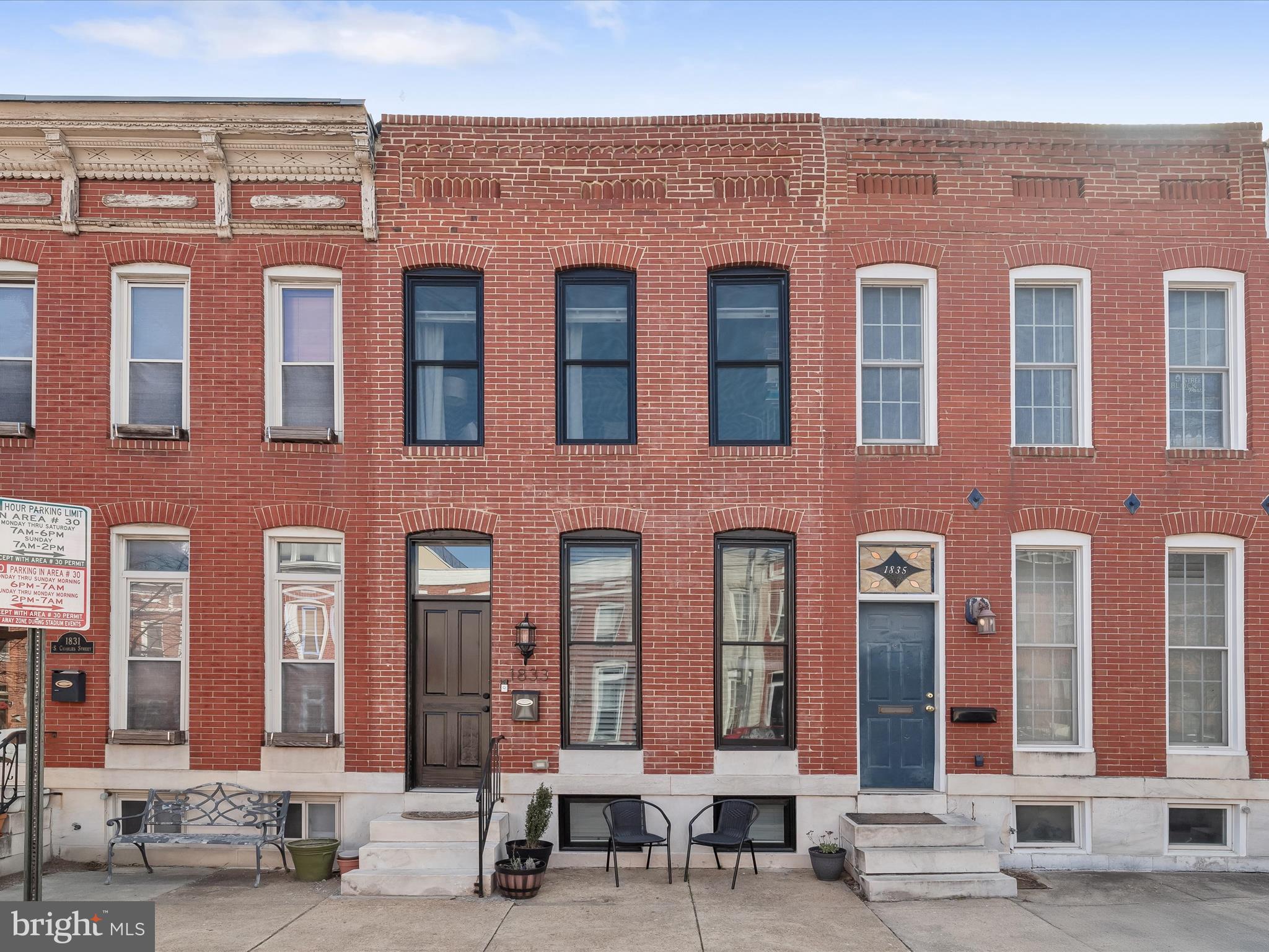 Approximately 6.5 years remain on the CHAP tax credit. Nestled in the heart of Federal Hill, this beautifully updated three-bedroom, three-bathroom rowhome spans three levels of living space and features a rooftop deck and parking pad. Completely renovated in 2021, the home blends timeless charm with modern updates throughout. Rich hardwood floors, a neutral color palette, recessed lighting, sun-filled windows, and a whole-home sound system create a warm, inviting atmosphere. The front living room boasts an elegant coffered ceiling and an exposed brick wall, while the dining room provides the perfect setting for meals. The kitchen is fully equipped with quartz countertops, a subway tile backsplash, 42-inch soft-close cabinetry, stainless steel appliances, and a breakfast bar with pendant lighting. A rear door offers direct access to the parking pad for added convenience. Upstairs, the primary bedroom features a luxurious ensuite bathroom with a walk-in shower. At the end of the hall, the second bedroom showcases an exposed brick wall. A second full bathroom with a walk-in shower, a laundry closet, and rooftop deck access complete the upper level. Downstairs, the finished lower level includes a third bedroom, a third full bathroom with a tub-shower, and a storage room. Located in one of Baltimore’s most sought-after neighborhoods, this home offers easy access to Riverside Park, Locust Point, and all that Federal Hill has to offer—top-rated restaurants, lively bars, boutique shops, entertainment, and everyday essentials just around the corner. Quick access to downtown, the Inner Harbor, major highways, and public transit ensures effortless commuting. A perfect blend of historic charm, modern updates, and incredible city living awaits!
