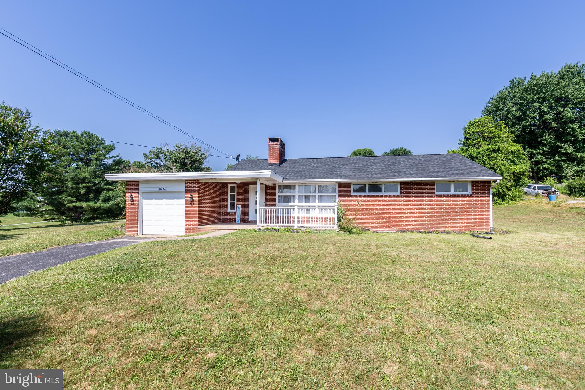 Welcome to 15022 Hanover Pike, a charming all-brick rancher located on a half-acre lot, ideally situated in Baltimore County between Hampstead and Reisterstown. This home has been thoughtfully enhanced with numerous recent improvements while preserving its classic appeal, including the beautiful original hardwood flooring throughout the main floor. The stunning 2024 kitchen renovation serves as the centerpiece of the home, featuring crisp cabinetry, quartz countertops, stainless steel appliances, ceramic tile flooring, and direct access to an outdoor seating area. Whether you're preparing everyday meals or hosting family and friends, this bright and inviting space is designed for both function and entertaining. Additional updates include new interior doors throughout the home (2024), new roof (2024) , and new windows in the bedrooms, bathroom, and basement, providing improved energy efficiency and abundant natural light (2024). Outside, the spacious and private backyard provides plenty of room to relax, garden, entertain, or simply enjoy the peaceful surroundings. The partially covered front porch and covered patio off the kitchen create the perfect spots for your morning coffee, while the stone patio offers an inviting space for more outdoor dining and gatherings. An attached one-car garage and generous driveway complete the package with added convenience.
Offering the charm of a classic brick ranch, the benefits of modern updates, and a desirable location with easy access to shopping, dining, parks, and commuter routes, this move-in-ready home is one you won't want to miss. Schedule your private showing today before this beautiful property is gone.