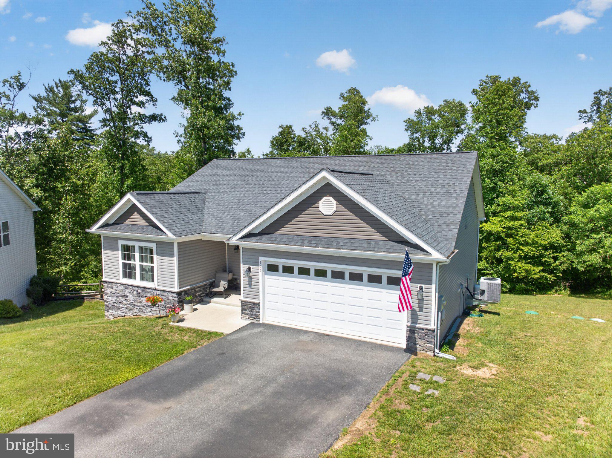 Situated on a quiet cul-de-sac in a sought-after community, this beautifully maintained ranch-style home offers the perfect blend of modern comfort and timeless appeal. Built in 2018 and set on 1.16 acres, this like-new residence features 4 spacious bedrooms, 3 full bathrooms, and exceptional attention to detail throughout.

Designed with today's lifestyle in mind, the open-concept floor plan seamlessly connects the well-appointed kitchen—featuring abundant counter space, stainless steel appliances, and ample cabinetry—to the dining area, making entertaining effortless. The inviting living room is centered around a cozy propane fireplace, creating the perfect gathering space on cool evenings.

The main level offers the convenience of three generously sized bedrooms, including a luxurious primary suite with an oversized walk-in shower and ample closet space. Additional highlights include recessed lighting, ceiling fans, custom finishes, and plentiful storage throughout the home.

The finished basement provides outstanding flexibility with a spacious recreation area, a fourth bedroom, a full bathroom, and additional storage—ideal for guests, hobbies, or multi-generational living.

Step outside to enjoy the peaceful, tree-lined backyard, offering privacy and a serene setting for outdoor living. Relax on the deck or patio, host summer barbecues, or take advantage of the outdoor storage shed for tools and lawn equipment.

Parking is easy with the attached front-entry garage and paved driveway, providing ample space for multiple vehicles.

This exceptional home combines comfort, style, and functionality in a picturesque setting. Conveniently located for commuters with easy access to Virginia, Maryland, Pennsylvania, and Washington, D.C., this is an opportunity you won't want to miss. Schedule your private showing today!