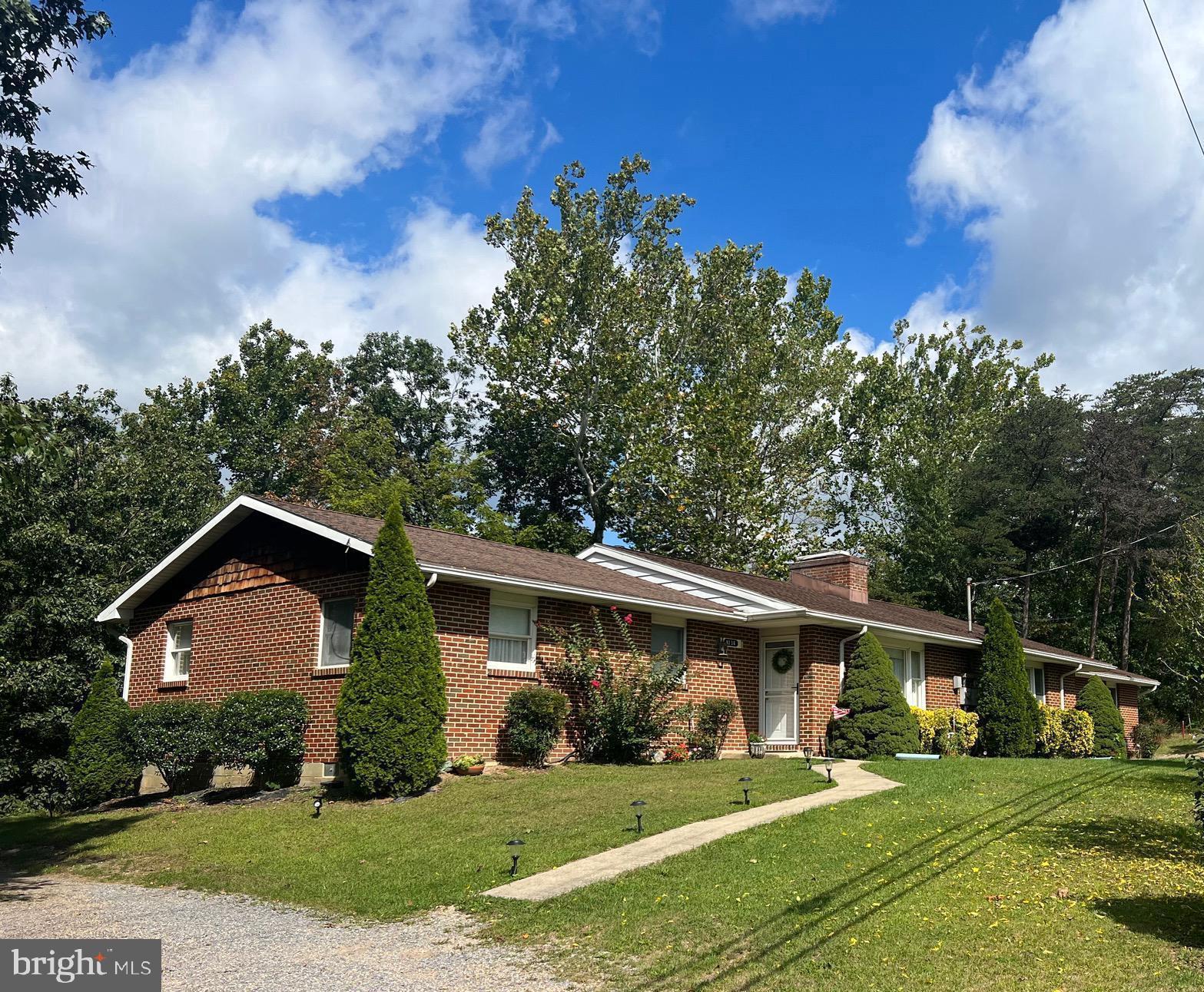 This beautiful brick duplex is located approx. 20min from downtown Berkeley Springs and just before Cacapon State Park! Each side of the duplex features a living room, eat in kitchen, laundry room, three bedrooms to include a primary bedroom with en suite bath, and a hallway bath. Each duplex also features a wood burning fireplace. Exterior features include a covered porch off the back of each side as well as a deck. This property really is a must see, call to make your appointment today! This property is also listed as residential, MLS # WVMO2003560.