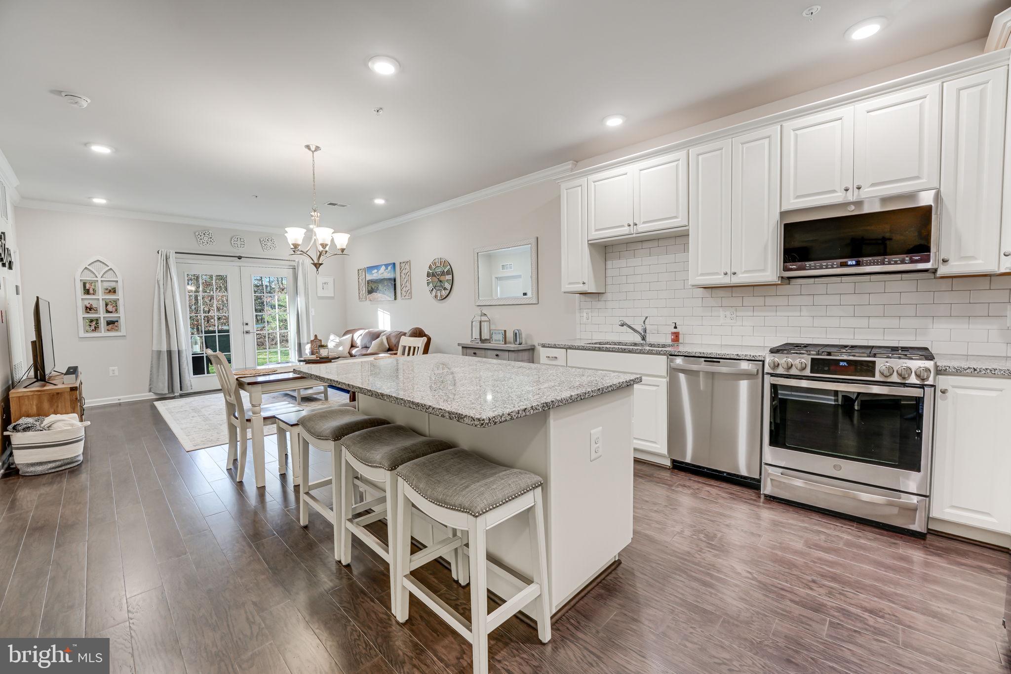 No steps -all main-level living!!  Plus an incredibly-low HOA/condo fee! Welcome to this charming 2-bedroom, 2-bathroom condo nestled in the heart of Ashburn, Virginia. This modern home, just four years young, boasts a contemporary and open design with no steps.    As you step into the inviting living space, you'll be greeted by an open floor plan that seamlessly connects the living, dining, and kitchen areas. The modern kitchen features white cabinetry, stainless steel appliances,  large center island perfect for gathering, modern tile backsplash & granite countertops making it a perfect setting for culinary enthusiasts.

The two spacious bedrooms offer comfort and tranquility, with the master bedroom featuring an en-suite bathroom for added convenience.  

Natural light floods the interior, enhancing the warmth and vibrancy of the living spaces. The condo also includes a private covered patio that backs to common area and trees, providing a serene outdoor retreat to unwind and enjoy the surrounding views.

The Ridges @ Loudoun Valley offers incredible amenities including three separate swimming pools, two fitness centers, tennis courts, tot lots and so much more!  

Located in Ashburn, this property offers proximity to a variety of amenities, including shopping centers, dining options, and recreational facilities. With no steps to navigate, this unit ensures easy living for individuals seeking a hassle-free lifestyle.   A short 9 minute drive to the Ashburn silver line metro station,  close proximity to the Greenway, Dulles International Airport, Rt 50 and more!  

Don't miss the opportunity to make this stylish and accessible condo your home. Schedule a viewing today and discover the comfort and convenience it has to offer.