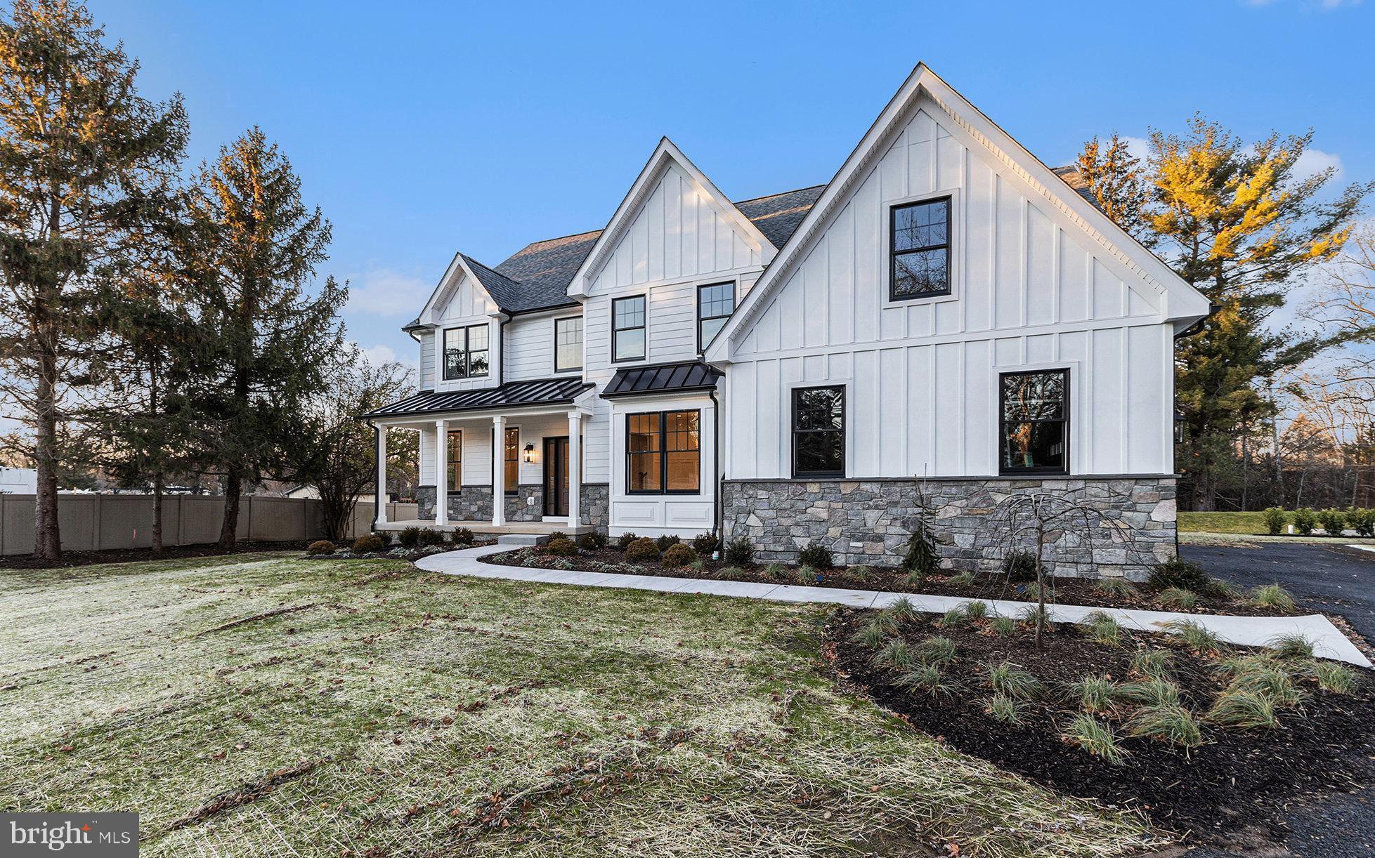 Back on the market following a change in buyer circumstances, presenting a rare second opportunity to own this exceptional new construction home.
Freshly Completed and Move-In Ready, 409 W. Butler Pike is a brand-new custom home blending refined craftsmanship with professionally curated interiors. Enjoy 4 bedrooms, 3 full baths, 2 half baths, and an expansive three-car garage. Located in the sought after Colonial School District this home is designed for modern living and situated on a beautiful full acre lot featuring mature trees and a flat back yard. Designed by R.A. Hoffman Architects and built by Blundin Builders with Parec Properties, the attention to detail in planning and execution will truly set this home apart. Just minutes from the heart of Ambler, the location offers easy access to a vibrant and charming small-town center.
Enter from the covered front porch through to the two-story foyer where you’ll find a private study with French doors to your left, perfect for working from home, and dining room to your right. Following along the main hall you pass an elegant staircase on your right, finished with white oak treads and custom newel posts, tucked away to your left is the formal powder room and coat closet.
The heart of the home is found at the rear, where the entry hall opens into a spacious family room and eat in kitchen that flow together seamlessly. Framed by expansive windows that flood the space with natural light, the kitchen is a true showpiece. Thoughtfully designed to combine function and style, it features a dramatic range wall with a Thermador gas cooktop, an oversized custom hood, and zellige tile backsplash. Warm wood lower cabinets are paired with crisp white uppers creating a timeless and updated look. An oversized island with seating provides the perfect gathering space, while a dedicated coffee bar, open wood accent shelving, and gleaming quartz countertops complete the space. Connecting the kitchen to your dining room for effortless entertaining, is an expansive butler's pantry featuring more custom cabinetry, quartz counters, a bar sink, and a built-in beverage fridge. Or dine alfresco, stepping outside onto your covered Trex composite deck, an ideal setting for warm-weather get-togethers. Rounding out the first floor and situated just off the kitchen is a convenient family entrance/ mud-room, complete with another half bath, walk-in pantry and custom built-in cubbies and hooks, providing the perfect drop zone for everyday organization just off the garage.
Ascending the staircase, you’ll find a spacious primary suite featuring a dramatic volume ceiling and two generously sized walk-in closets with custom closet organization systems. The luxurious primary bathroom offers a serene retreat, complete with a soaking tub, a large spa-style shower, and custom dual vanity for a truly elevated experience. Bedroom 2 offers the privacy of its own en-suite full bathroom with a tiled shower and custom vanity. Bedrooms 3 and 4 each feature walk-in closets and share a well-appointed Jack-and-Jill bathroom. Also on the second floor is a convenient laundry room, complete with a utility sink, built-in cabinetry, a folding area, and a storage closet, designed for maximum functionality.
Additional highlights include black Andersen 400-series windows, Hardie Plank siding with board and batten accents, a 25-year architectural shingle roof, and upgraded standing seam metal roofs on the front and side porches. Inside, custom lighting, designer-selected plumbing fixtures and upgraded marble and tile selection layouts add a refined touch throughout. A dual-zone HVAC system ensures year-round comfort. These carefully curated finishes and systems reflect a level of quality and sophistication far beyond typical “builder-grade” home.