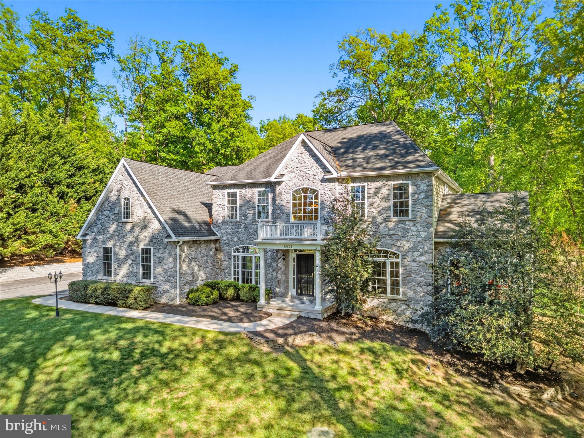 Welcome to 13903 Mitchell Court, an extraordinary luxury residence ideally situated on the highly sought-after Frederick County side of Mount Airy. Expertly crafted with timeless design, exceptional attention to detail, and upscale finishes throughout, this stunning home seamlessly blends elegance, comfort, and modern functionality. From the moment you arrive, the home’s impressive curb appeal sets the tone, featuring a striking custom stone elevation, professionally landscaped grounds with multiple electric access points in both the front and rear yards, and a welcoming covered entry. Step inside to discover a grand interior highlighted by a dramatic two-story foyer, 10-foot ceilings on all three levels, gorgeous hardwood flooring, abundant natural light, and an open, flowing floorplan designed for both everyday living and sophisticated entertaining. The main level offers beautifully defined yet connected spaces, including formal living and dining rooms perfect for hosting gatherings or enjoying quiet evenings at home. The spacious sunroom provides incredible flexibility and could easily accommodate a pool table, shuffleboard, grand piano, or simply serve as a tranquil sitting area surrounded by natural light and greenery. At the heart of the home, the gourmet chef’s kitchen is designed to impress, showcasing custom cabinetry, under-cabinet and in-cabinet lighting, granite countertops, premium stainless steel appliances, oversized center island with seating, walk-in pantry, elegant butler’s pantry, and seamless connection to the surrounding living and dining spaces. The adjacent breakfast room is flooded with natural light and features vaulted ceilings and stunning rounded windows that create an airy, elevated atmosphere. The inviting family room is anchored by a custom floor-to-ceiling stone wood-burning fireplace and complemented by expansive, thoughtfully designed living space ideal for entertaining or relaxing. A private main-level office with French-door entry provides the perfect work-from-home setup with both style and functionality. Upstairs, retreat to the luxurious primary suite featuring cathedral ceilings, a spacious sitting area with skylights and a cozy gas fireplace, two oversized walk-in closets, and a spa-inspired ensuite bath complete with a soaking tub, oversized Roman-style walk-in shower, dual vanities, and beautifully curated finishes. Additional bedrooms are generously sized and offer ensuite or convenient hall bath access, providing exceptional comfort and privacy for family and guests alike. The fully finished lower level expands the home’s versatility with an ideal setup for entertaining, extended stays, or multi-generational living. Highlights include a brand-new gourmet second kitchen, updated full bathroom with modern finishes, expansive recreation and living spaces ideal for a media room, gym, or play area, a fifth bedroom perfect for an in-law suite, and abundant storage throughout. Outdoor living is equally impressive, offering a private backyard retreat complete with a covered Trex deck, extensive hardscaped patio, permanent fire pit, and fully fenced yard surrounded by mature landscaping for added privacy and enjoyment. Additional notable features include a 3-car side-load garage with at-home electric vehicle charger, shed with electric, 400-amp electrical service, built-in surround sound, automatic lighted window candles, full water softener system, built-in shelving, brand-new double oven and refrigerator, and dual-zone HVAC systems replaced just two years ago. Conveniently located near Downtown Mount Airy, major commuter routes, shopping, dining, healthcare, and local favorites including Linganore Winecellars, Red Shedman Farm Brewery, and Black Ankle Vineyards, this is a rare opportunity to own a truly exceptional property where luxury, comfort, and lifestyle come together seamlessly. Schedule your private tour today.