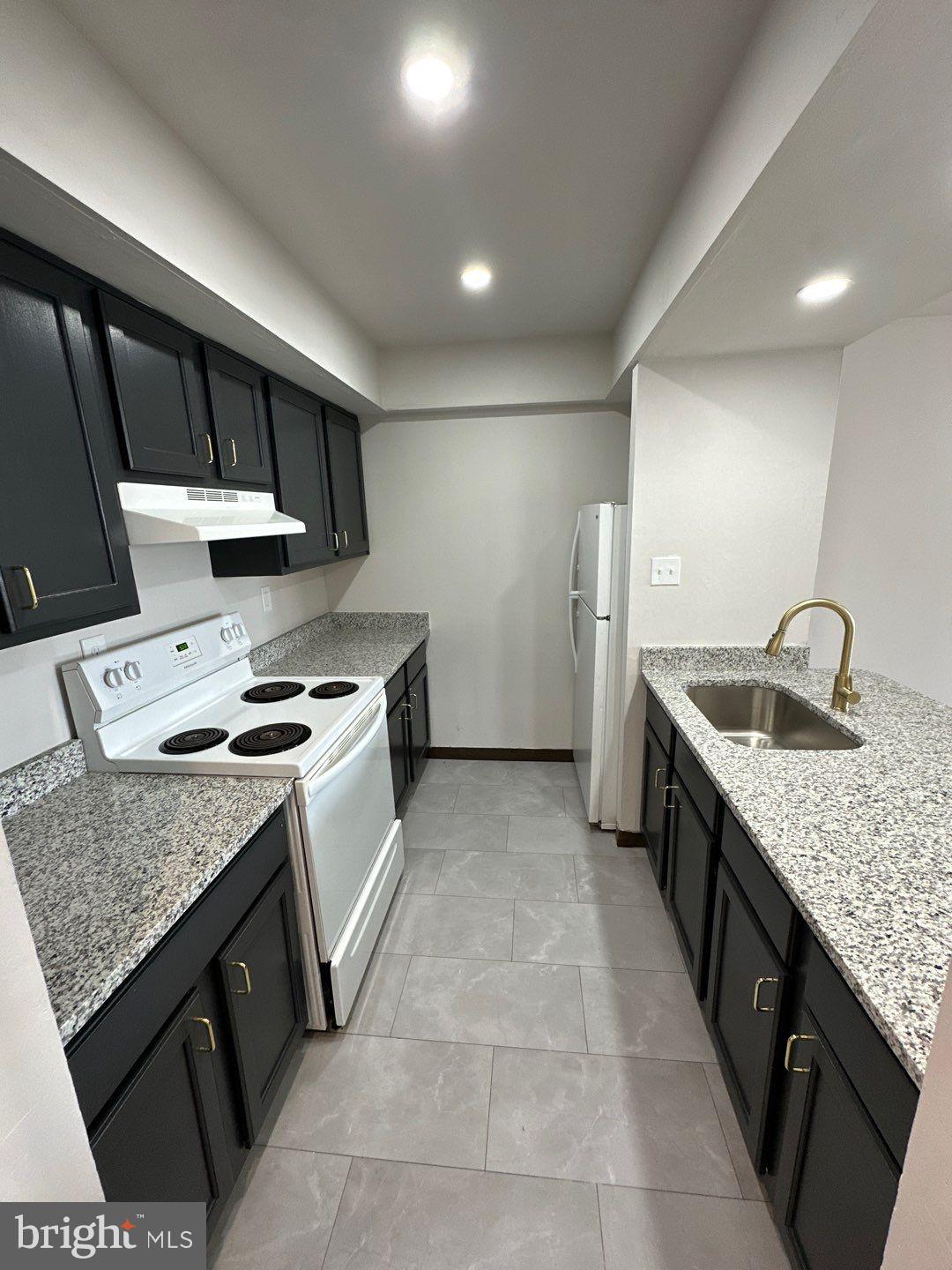Tastefully updated, spacious , and bright - 2 bedroom, 2 full bath apartment awaits its new resident. Great location on Rhawn within easy walk to Winchester Park, or Frankford Avenue. Apartment has been redone to include solid surface flooring throughout. Kitchen has granite and large island great for dining, but there is also space for a formal dining table. Recessed lighting throughout. Laundry room on site. Owner pays cold and hot water, sewer, trash.
