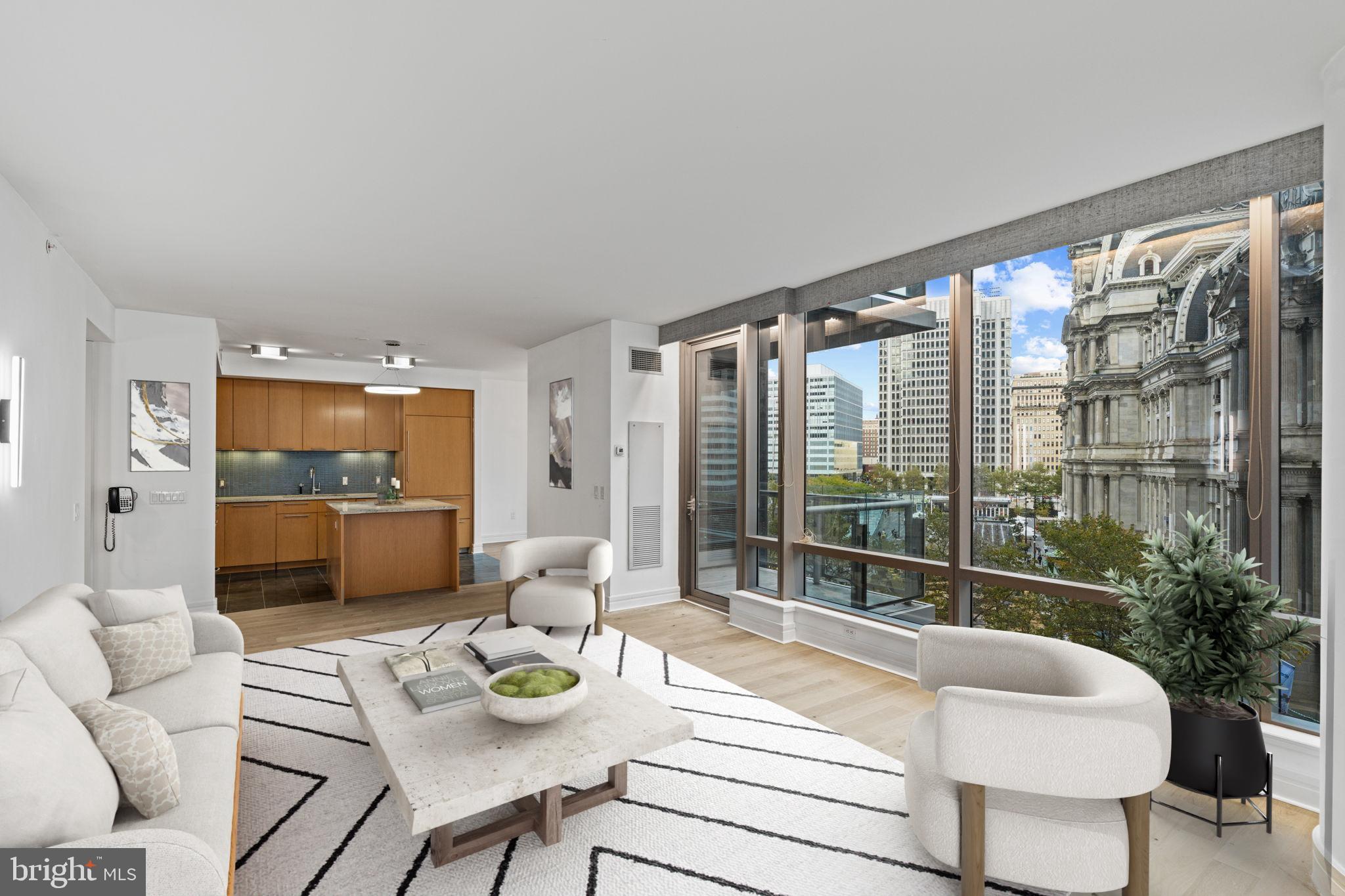 Completely redesigned. Totally unique. Instantly unforgettable. This layout is the only floorplan featuring a private balcony.   It has brand-new White Oak wide plank hardwood throughout. Expansive floor-to-ceiling windows frame iconic views of Philadelphia’s City Hall, creating the perfect backdrop for refined urban living. The chef’s kitchen has high-end appliances, granite countertops, with a view of City Hall. The primary suite is spacious and serene, offering a Calcutta Gold marble bath with soaking tub and separate glass-enclosed shower. An extra large second bedroom (or flex office/guest space) plus a 3rd Guest Bedroom and additional full bath complete the thoughtful layout. Residents enjoy 10,000 sq ft of unmatched amenities, including an indoor pool, state-of-the-art fitness center, yoga/wellness room, private resident lounge, screening room, and expansive outdoor terrace with grilling stations, dining areas, and fire pits — all overlooking City Hall. Add in valet parking, 24-hour concierge, chauffeur service, and direct access to the Ritz-Carlton Hotel and Spa, and you have a residence that redefines Center City luxury.
