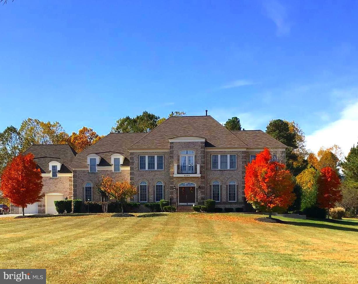 4 Separate - 3D Tours (1 for each level & in-law suite) available in MLS!  LUXURY & LOCATION!   Your retreat is located in the affluent Windsong Subdivision! Almost 12,000 sq feet, with over 8,000 finished, plus 3,700 more to customize your way  on 2 acres, set back off the main road. Beautifully manicured yard & custom landscaping welcome you to the exquisite French door entrance. As you step into grand foyer, you're greeted by stunning hardwood floors, 2 story ceilings, and the 1st of 3 staircases to the upper level.  2nd staircase accessed from kitch/family rm. Main level features a large library, dual entry. Sunroom/Florida Rm surrounded by natural light lead to the cozy reading/sitting rm. Grand pillars, crown molding, wainscoting and endless table space invite you into the formal dining rm w/ access to the butler's pantry.  Enter into the culinary dream kitchen!  Endless counter space, 42" upgraded cabinets, oversized island & breakfast bar, large table space, SS appliances including side by side energy efficient refrigerator and dishwasher, in addition to dual ovens, built-in microwave & gas cooktop. Plus, a coffee bar, WI pantry, workstation and recessed lighting.  Kitchen has open view into the enormous Florida rm !  Walk outside thru French doors to your almost no maintenance composite deck, and stone patio extending the entire length of the house! Back inside, the family rm boasts, WOW with it’s 2 story ceilings, countless windows for tons of natural light, floor to ceiling stone gas fireplace and welcomes any size furniture!  Main level also offers two 1/2 baths, multiple storage/coat closets & laundry rm with utility sink.  3rd staircase leads to the private, separate in-law suite featuring  an efficiency kitchen, dining area, full bath, family room, large walk in closet and private bedroom quarters.  Perfect for guests or extra income!  From the main level foyer/family rm staircase, we ascend to an open, wide hallway that offers  space for a sitting area. This level features 4 exceptionally large bedrooms. The primary suite is your own private oasis.  Features a two sided marble gas fireplace with views from the enormous sleeping area and the overly large, open primary sitting rm .  Includes 2 large walk in closest/dressing rm. The luxurious, primary bath is your own private spa! 2 separate vanities w/ tons of cabinet space, plus dressing station, raised jetted soaking tub surrounded by windows/natural lighting, recessed lights and ceiling fan.  The separate oversized shower has multiple shower heads and seating.  Primary bath has separate water close, bidet & closet space.  Primary bedroom's most amazing feature is the very large, exquisite, private, covered veranda. All bedrooms have have ensuites, all but one has a sleeping area, separate, but adjoining sitting rm, and two large WICs.  Upper lev has 2nd laundry rm w/ utility sink & lots of closet storage. The approx 3,700 sq foot unfinished basement has endless potential with a RI for a wet bar and RI for a bath. Basement access inside and has it's own exterior entrance & lots of windows.  Home also features 2 separate oversized, 2 car garages, front loading & side loading plus large storage shed for your outdoor toys/tools! Solar panels reduce utility costs dramatically!  Buyer must take over solar panel lease.  3 New AC Units just installed! New Roof 2023!  Dual zone HVAC, Interior & Exterior sprinklers system, dual water heaters! Located near endless shopping, dining, entertainment! Short commute to DC, VA, National Harbor, Andrews AFB, Bolling AFB, PAX River and Indian Head Naval Base.  View the FOUR SEPARATE 3D TOURS IN MLS - (1 per level & 1 for in-law suite) - Back up offers welcome!