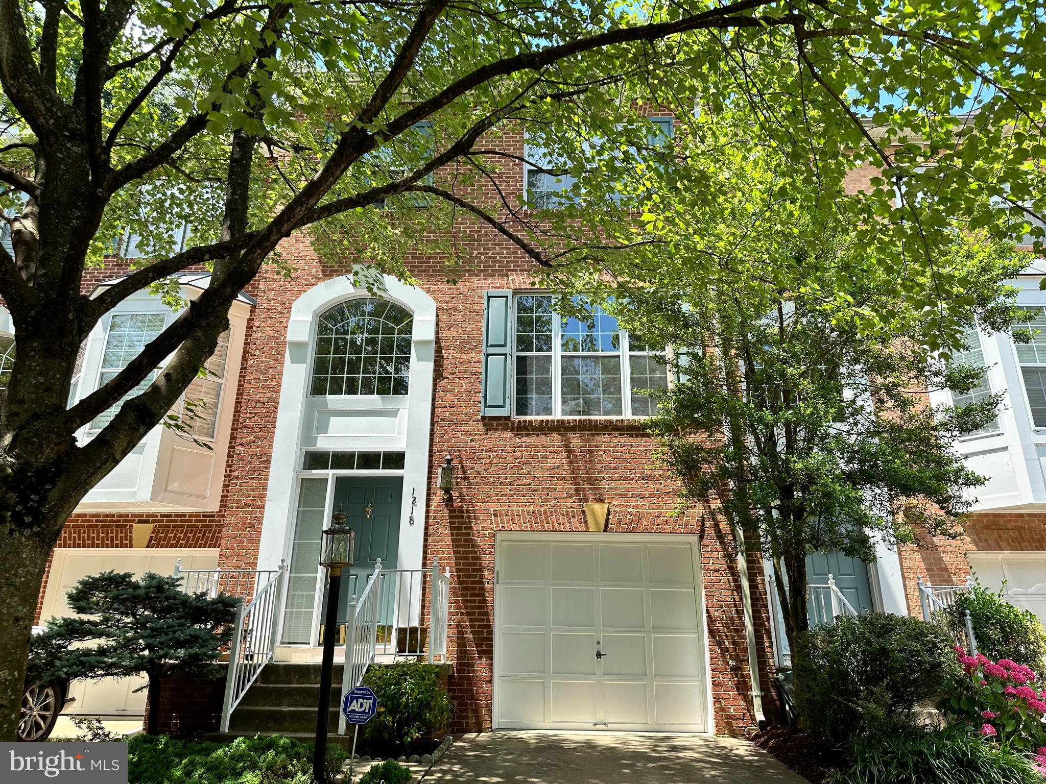 Brilliantly Upgraded Three-Level Townhome with Vaulted Ceilings, Fenced Backyard and Huge Recreation Room! Ideally located in a quiet community in the heart of North Reston, this 3 bedroom 3.5 bathroom residence emanates classic colonial vibes with a beautiful brick façade and vibrant mature landscaping within walking distance to the North Point Shopping Center. Freshly painted with modern tones, the interior charms the senses with an array of functional and stylish upgrades. Overflowing with welcoming warmth, the main-level features soaring foyer ceiling, gorgeous hardwood floors, soft natural light, powder room, family room with cozy fireplace, living room with picture window, and a formal dining area. The gourmet kitchen satisfies culinary desires with modern gray cabinetry, stainless-steel appliances, granite countertops, tile backsplash and an adjoining breakfast nook with access to the raised deck. Boasting impressive amounts of space, the primary bedroom continues to delight with a spacious walk-in closet, vaulted ceilings, sitting area, new plush carpet, and an en suite with a soaking tub, dual sinks, and a separate shower. Two additional bedrooms with vaulted ceilings and a full bathroom finish out the upper-level.  Explore the finished walkout lower-level, which has a laundry area, powder room, coat closet, brand-new soft carpet, and an oversized recreation room. Additional features include an attached one-car garage, fenced-in backyard, close to Reston Town Center, 9.5-miles to Dulles International Airport, near shopping and restaurants, and more! Immerse yourself in the Reston’s planned community with 15 pools, 55 miles of trails, 4 lakes, expansive parks, numbers tennis & pickle ball courts, and Nature Centers. Virtually staged.