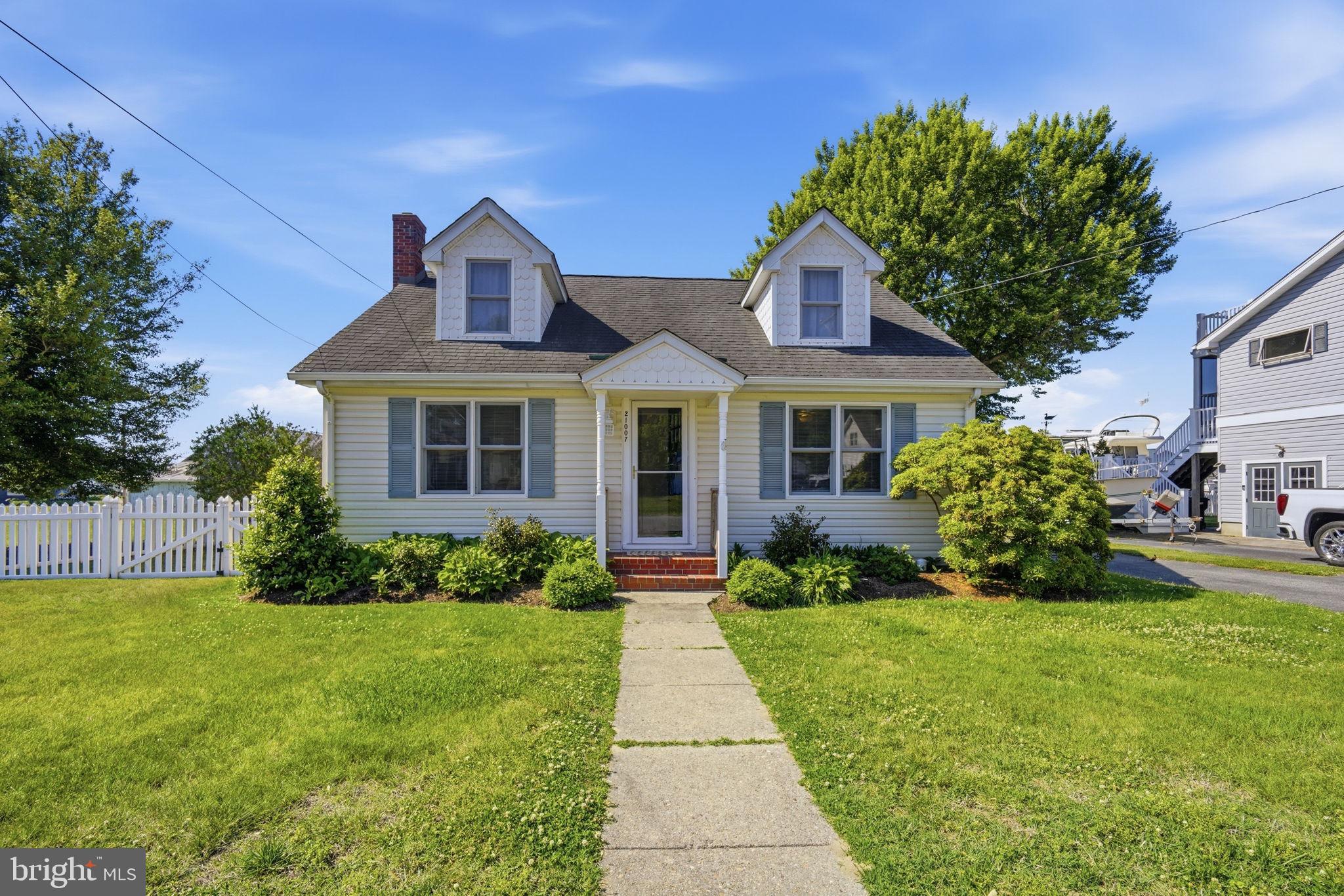 Adorable updated cottage in the heart of town on popular Bayside Avenue offering approximately 1,400 sq. ft. of charming coastal living. This delightful Cape Cod features 3 bedrooms and 2 full baths, with seasonal water views of Rock Hall Harbor from the second floor. The main level offers an open floor plan with a cozy propane fireplace, 2 bedrooms, and 1 full bath, while the entire upper level serves as a spacious private primary suite.

Enjoy outdoor living in the fenced rear yard — perfect for pets, entertaining, or relaxing on the back deck while taking in the scenery. A detached one-car garage and storage shed provide plenty of room for bikes, tools, kayaks, and LSV/golf cart storage.

Ideally located within walking distance to local favorites including Harbor Shack and Waterman’s Crab House, marinas, harbor festivities, shops, and more. Conveniently situated along the complimentary Rock Hall Rides shuttle route, making it easy to enjoy everything this waterfront town has to offer!