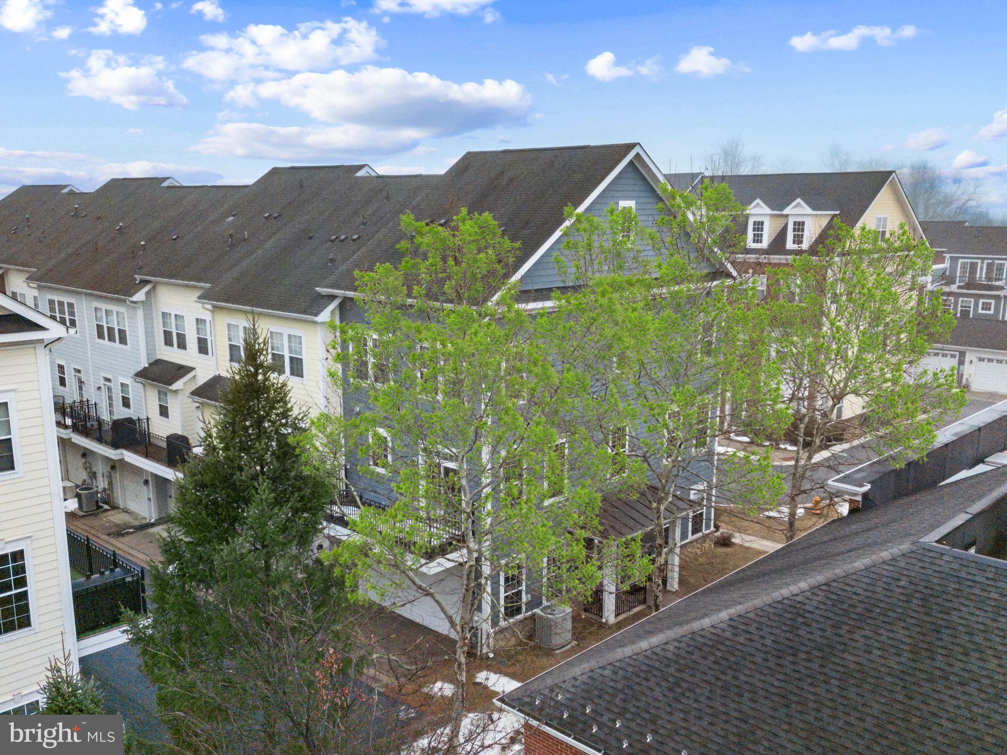 OPEN HOUSE SUN, JULY 26TH 1-3:30PM!You will love this sunny, 3-4 BR, 2.5 BA, 2-car garage end-unit townhome just a stone's throw to the Shipley's Grant Shopping Center and 1.5 blocks to the pool and club house! Boasting 9-ft ceilings, floor-to-ceiling windows, freshly painted with recessed lighting throughout, bedroom-level full-size laundry, one of the longest decks in the neighborhood and 3 fully finished levels, this 2009,  Bozzuto-built residence does not disappoint! Hardwood floors span  the main living level and carpet that was installed in December 2025 are in the bedrooms. All bathrooms are very roomy with designer lighting fixtures, ceramic tile flooring and tubs and showers. The lower level is a full walk-out and has lots of light and a possible 4th bedroom and office or additional family room.  The 2-car garage is in the rear of the house and additional parking for guests is available for free in the shopping center next door.  Unique features include the queen-size 2nd and 3rd bedrooms which also easily hold a desk and/or dresser, Samsung washer (2021) , very wide hardwood staircases, throughout,  HVAC located in garage, Whirlpool microwave (2026), Samsung refrigerator-freezer with exterior water and ice door and icemaker (2019), 42" high wood kitchen cabinetry, gorgeous designer tile backsplash highlights the  many granite counters throughout the kitchen, island for seating and kitchen prep in addition to the large table-space area with designer light fixture; 2 pantry closets, lazy Susan cabinet, and spacious front porch! The Shipley's Grant community is full of amenities: fitness center, 2 pools, 2 club houses, tot lot, playground, walking and jogging paths. The shopping center sports a drive-through Starbucks and many restaurants, spa, and boutique shops.  Best of all you are around the corner from beltway access to Rte 100, I-95, I-495, Rte 50 and Baltimore is only 20 minutes away! Everything you need is here--look no further!