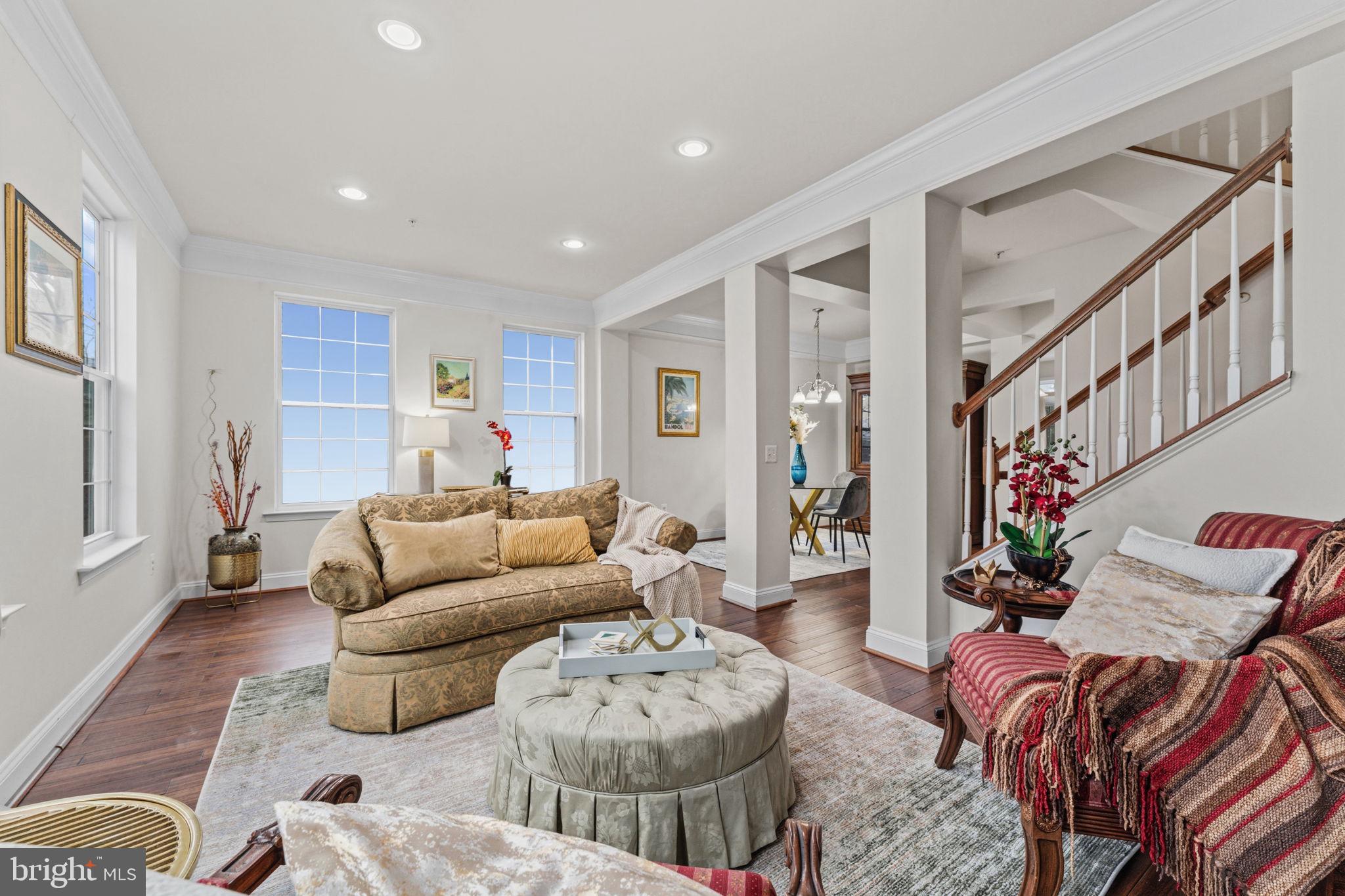 You will love this sunny, 3-4 BR, 2.5 BA, 2-car garage end-unit townhome just a stone's throw to the Shipley's Grant Shopping Center and 1.5 blocks to the pool and club house! Boasting 9-ft ceilings, floor-to-ceiling windows, recessed lighting throughout, bedroom-level full-size laundry, one of the longest decks in the neighborhood and 3 fully finished levels, this 2009,  Bozzuto-built residence does not disappoint! Hardwood floors span  the main living level and carpet that was installed in December 2025 are in the bedrooms. All bathrooms are very roomy with designer lighting fixtures, ceramic tile flooring and tubs and showers. The lower level is a full walk-out and has lots of light and a possible 4th bedroom and office or additional family room.  The 2-car garage is in the rear of the house and additional parking for guests is available for free in the shopping center next door.  Unique features include the queen-size 2nd and 3rd bedrooms which also easily hold a desk and/or dresser, Samsung washer (2021) , very wide hardwood staircases, throughout,  HVAC located in garage, Whirlpool microwave (2026), Samsung refrigerator-freeer with exterior water and ice door and icemaker (2019), 42" high wood kitchen cabinetry, gorgeous designer tile backspash highlights the  many granite counters throughout the kitchen, island for seating and kitchen prep in addition to the large table-space area with designer light fixture; 2 pantry closets, lasy Susan cabinet, and spacious front porch! The Shipley's Grant community is full of amenities: fitness center, 2 pools, 2 club houses, tot lot, playground, walking and jogging paths. The shopping center sports a drive-through Starbucks and many restaurants, spa, and boutique shops.  Best of all you are around the corner from beltway access to Rte 100, I-95, I-495, Rte 50 and Baltimore is only 20 minutes away! Everything you need is here--look no further!
