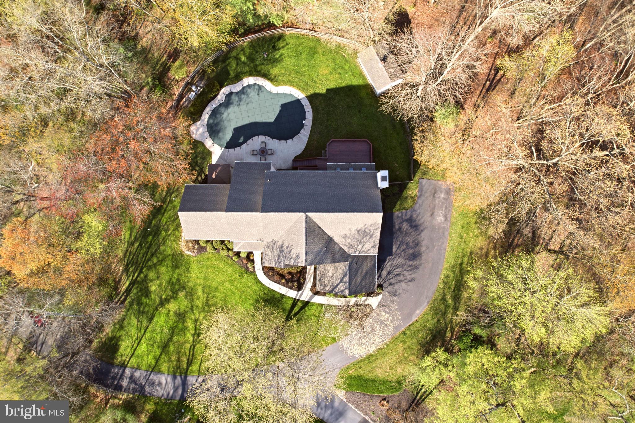 Just minutes from the vibrant dining, shopping, and lifestyle of West Chester, this home offers the rare combination of convenience and complete privacy, set on 1.6 wooded acres with a true resort-style indoor-outdoor living experience.

This is not your typical floor plan. A stunning staircase creates a striking focal point, while the living room with cathedral ceilings and the dining room with vaulted ceilings transform traditionally standard spaces into architectural highlights. The main level also features a private study with glass doors, ideal for working from home.

The high-end kitchen, updated in 2021, anchors the home with stacked cabinetry to the ceiling and a beautifully detailed backsplash. The breakfast area offers sliding glass doors to the deck and flows seamlessly into an expansive family room. Multiple sets of sliding doors open to the outdoor living space, and an abundance of oversized windows brings natural light in from every angle, creating a seamless connection to the outdoors.

A recently renovated powder room and laundry room complete the main level. The garage features epoxy flooring, EV charging capability, and a stainless steel utility sink.

Upstairs, the primary suite is designed for comfort and function, featuring two walk-in closets, a sitting room, and a spa-style bath. Each of the two additional bedrooms includes a private en-suite bath and a walk-in closet - a rare find.

The garden-level lower level expands the home’s versatility with a fourth bedroom and full bath, an additional room ideal for a home office, gym, media room, or in-law suite, along with substantial open space offering endless possibilities. This space is tied in beautifully to the outdoors with multiple full size windows and sliding glass doors to the patio. Outdoor living is where this property truly stands apart. Surrounded by mature trees for privacy, the backyard is designed to feel like your own private retreat. The in-ground pool serves as the focal point for summer living and entertaining, while the hot tub offers a year-round escape for relaxation. The expansive deck, accessed directly from the home, creates effortless flow for indoor-outdoor living and provides the perfect setting for dining, gathering, or simply enjoying the peaceful, wooded surroundings.

A few notable updates are a newer roof (2021), hot water heater (2021), whole-house generator (2022), and refinished hardwood floors (2021).

Perfectly positioned, the home is approximately 27 miles from Philadelphia International Airport, 4 miles from Stroud Preserve with over 570 acres of protected land and hiking trails, and 3 miles from West Chester Golf and Country Club, with easy access to Routes 202 and 322.

Located within the Henderson High School boundary and close to numerous private and parochial school options, this is a rare opportunity to own a move-in ready home with acreage, modern upgrades, and flexible living space in a prime West Chester location. 520 Sunset Hollow Rd is where everyday living feels like a retreat.