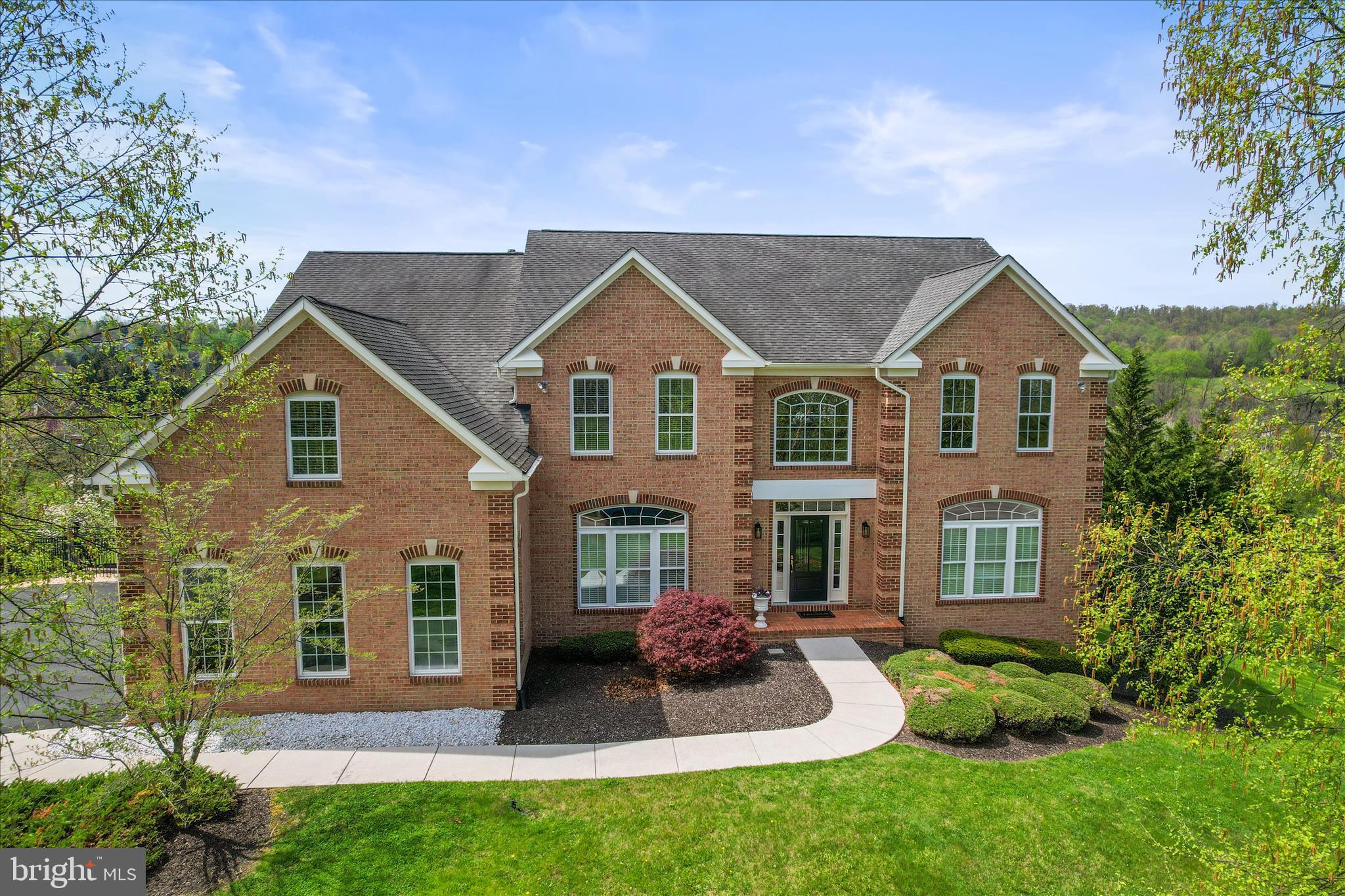 This grand home is better than new with ALL the bells and whistles icluding a BRAND NEW ROOF!! Beautiful Hardwood flooring, Double hardwood staircases, huge kitchen with Stainless Steel appliances including double wall ovens. Large kitchen island with bar seating at the granite countertops, breakfast area, bright sunroom leading to composite decking with retractable awnings to enjoy the beautiful countryside . Walk in pantry, butler pantry, Formal living and dining rooms and office with french doors.  Everything you can imagine!  The double hardwood staircases to the 2nd floor. One staircase leads to game room with full bath and walk in closet. (or4th BR)   Other side has the bedrooms 2 with a jack n jill bath. Primary BR suite has double door entry, tray ceiling, new ceiling fan, 2 walk in closets, primary bath with soaking tub with jets, walk in shower, cathedral ceiling! Huge decks with remote awnings  5153 Finished SF above grade and another 2431 SF unfinished lower level walkout to covered patio and rough in full bath! Beautiful inground pool to enjoy while overlooking the countryside!  Remote blinds in 2 story family room. Whole house speaker system, including outside! Remote awning covering pool paver patio.  3 car garage, Mud room with built in bench, 1st floor laundry with cabinets and utility sink!  Central vac! The list is endless!!  NEW ROOF BEING INSTALLED BEFORE SETTLEMENT!