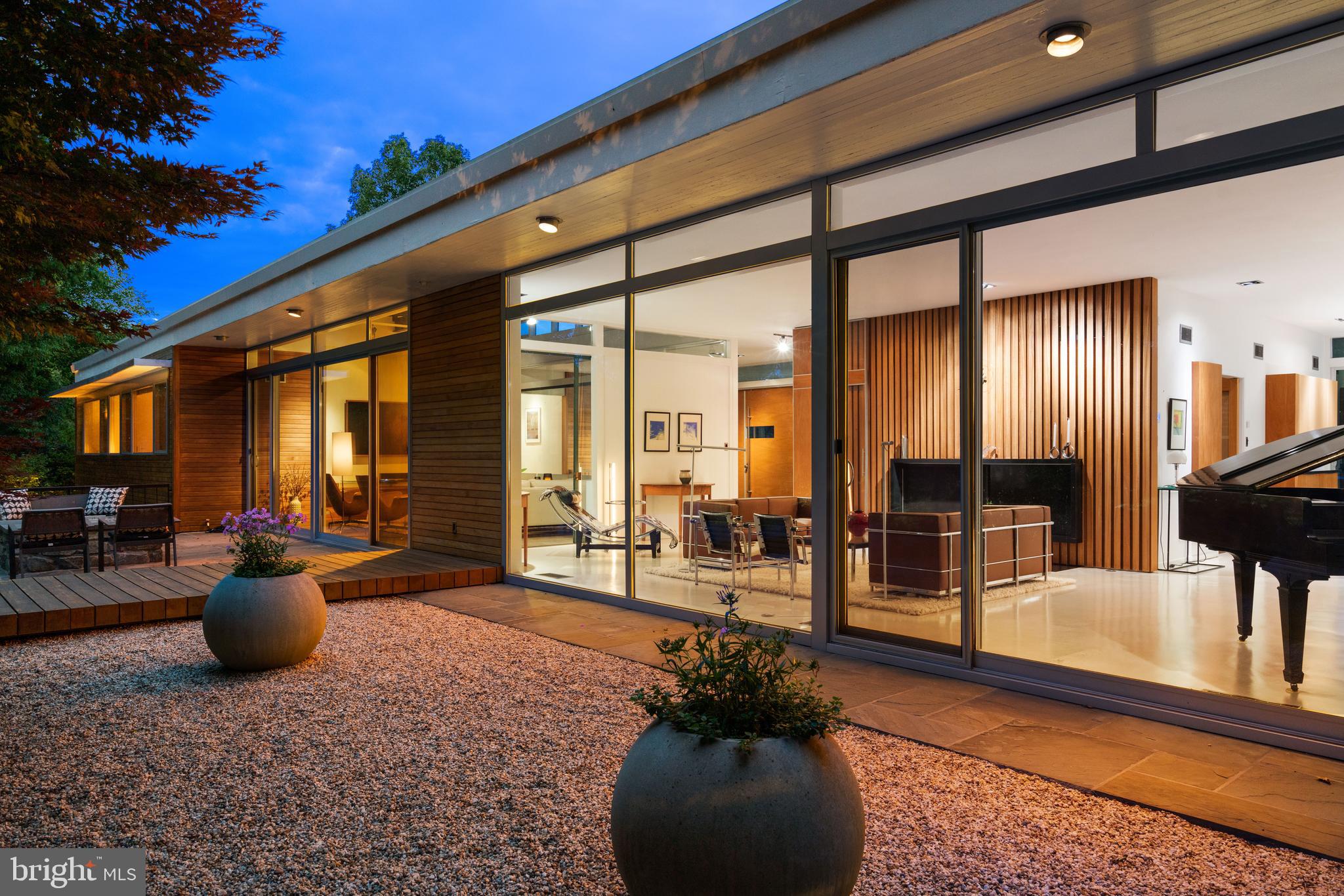 Broker's Open House - Tuesday, June 2nd from 1pm to 3pm. There are homes that simply exist, and then there are homes that leave a lasting architectural impression. 2533 North Ridgeview is firmly the latter.

Privately set within one of North Arlington’s most serene, verdant settings, this authentic mid-century modern residence was originally designed in 1952 by acclaimed architect Donald Lethbridge, with the current owners approaching the restoration with exceptional care and respect for the home’s original architectural integrity. High-performance insulated glass systems replaced the original windows without compromising sightlines, while modern lighting, mechanical systems, and smart home technology were seamlessly integrated to elevate the daily living experience.  

Designed to live in harmony with its surroundings, the home seamlessly blends light, and landscape in a way rarely achieved today. Spanning more than 5,000 square feet, hidden steel beams allow dramatic open spaces while walls of windows dissolve the boundary between indoors and out, framing sweeping views toward Rosslyn, Washington, DC, and the National Cathedral beyond. Natural landscape and mature greenery surround the home, inviting light to flood the interiors while preserving an extraordinary sense of privacy.

Unlike a conventional open plan, each room was thoughtfully designed as its own distinct experience, balancing openness with intimacy and creating a remarkable rhythm throughout the home.

The home’s design is not simply aesthetic, but deeply intentional. Dramatic cantilevered overhangs were engineered to welcome warm winter sunlight deep into the interiors while shielding the home from the higher summer sun, naturally regulating light, warmth, and comfort throughout the seasons. Stone floors transition into stone terraces and outdoor living spaces, further blurring the distinction between indoors and out, while reinforcing the home’s connection to its natural surroundings.

Surrounded by mature greenery and immersed in privacy, North Ridgeview feels worlds away while remaining moments from the city, and the best of local shops, restaurants and parks. Architecturally significant yet deeply livable, 2533 North Ridgeview represents a rarely available opportunity to own an elevated piece of Washington-area modernist history.