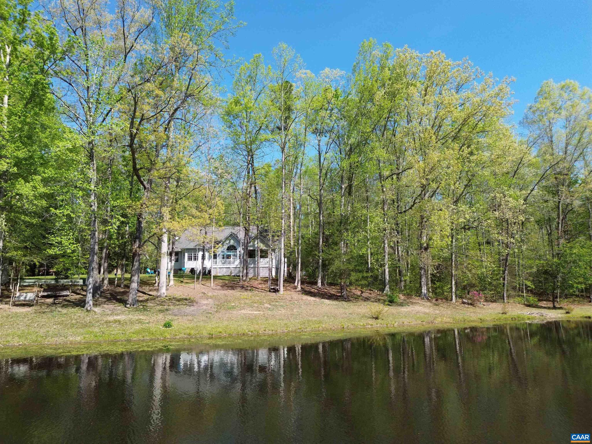 Experience the perfect blend of serenity and convenience in this stunning waterfront retreat in Goochland County, less than 3 miles from I-64. Offering an easy commute to Short Pump and Charlottesville, this home provides a rare "vacation at home" lifestyle on a semi-private 7+ acre lake. Your backyard is a private sanctuary for boating, fishing, & wildlife viewing. The 7-acre exterior features a charming covered front porch, a lakeside pergola, & a whole-house generator. Inside, the expansive family room boasts vaulted ceilings & panoramic lake vistas. The chef?s kitchen is equipped with stainless steel appliances, a center island, & a sun-drenched breakfast nook. Retreat to the main-level primary suite, featuring two walk-in closets & a remodeled spa-like bath with a soaking tub and dual vanities. Two additional bedrooms & 1.5 baths round out the main level, while a versatile bonus room above the garage serves as a perfect office or fourth bedroom. Relax in the bright sunroom or on the oversized deck. Functional highlights include a large laundry room and an extra-large side-load 2-car garage. Unique upgrades include electricity & water lines run to the driveway.,Fireplace in Family Room
