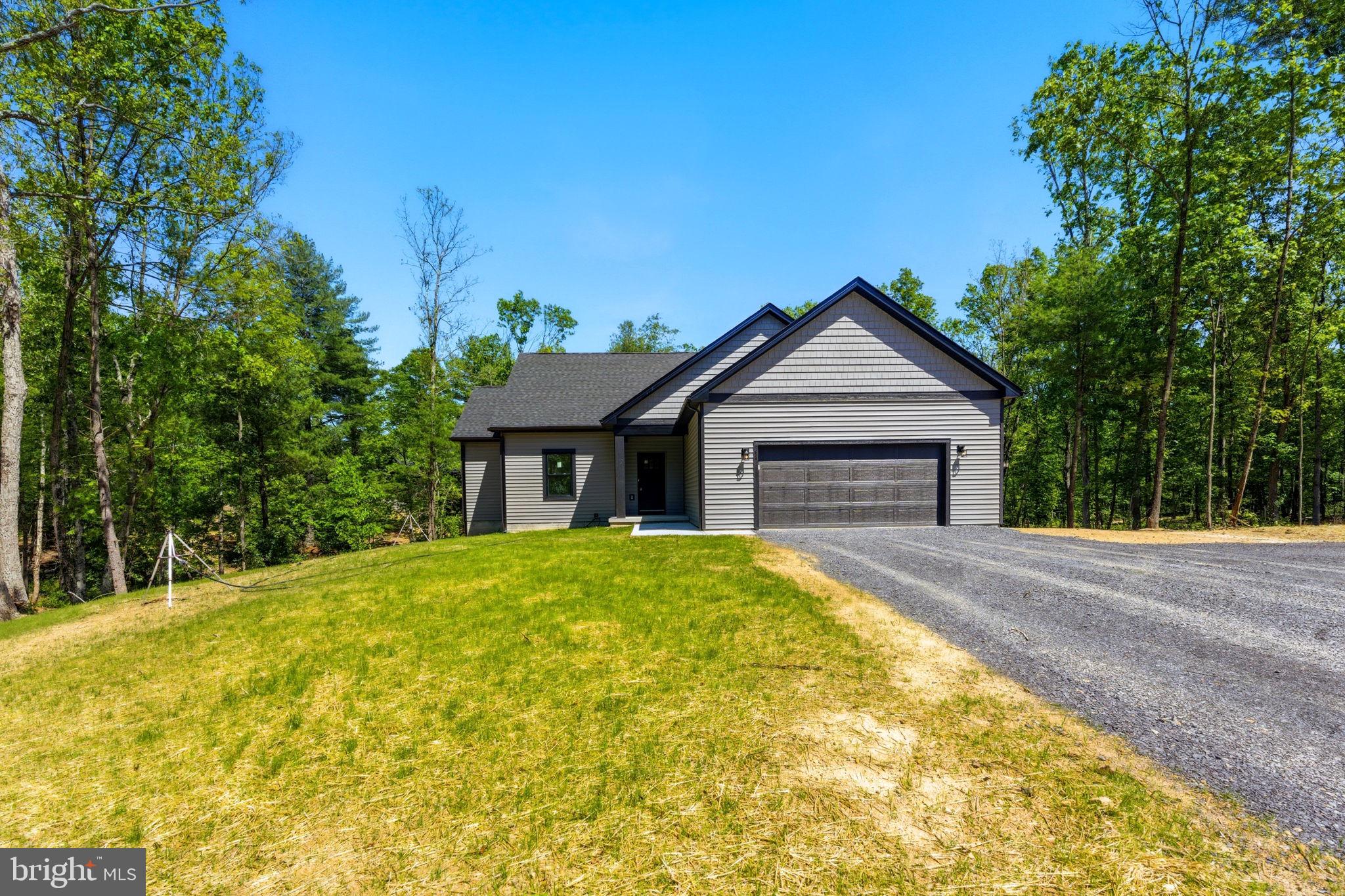 Nestled on a private, wooded 2+ acre lot, this beautiful home offers the perfect balance of peaceful country living and modern convenience. Featuring 3 bedrooms and 3 full bathrooms, this thoughtfully designed residence provides plenty of space for comfortable everyday living and entertaining.
Inside, you'll find luxury vinyl plank flooring throughout the home, creating a seamless and durable living environment. The open-concept floor plan showcases a well-appointed kitchen complete with granite countertops, stainless steel appliances, and ample cabinet space. The adjoining living area is highlighted by a cozy LP fireplace, making it the perfect place to gather with family and friends.

The finished basement significantly expands the home's living space and offers endless possibilities for a recreation room, home theater, home office, fitness area, or guest accommodations. A full bathroom in the basement adds flexibility and convenience.

Surrounded by mature trees and natural beauty, the private 2+ acre lot provides plenty of room to enjoy the outdoors, whether relaxing on the porch, entertaining guests, or exploring your own wooded retreat. Combining modern finishes, spacious living areas, and a desirable private setting, this exceptional property is ready to welcome you home.