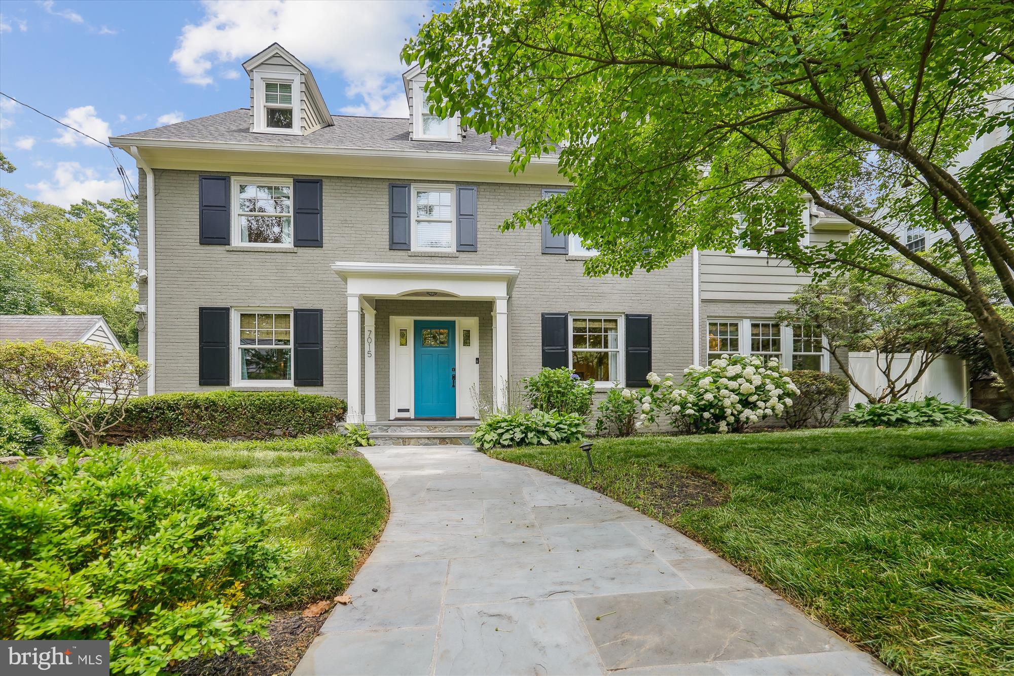 Nestled on a picturesque, tree-lined street in the heart of the Town of Chevy Chase, this stately 4-level Colonial blends classic elegance with modern sophistication. Thoughtfully designed with high-end finishes throughout, the home welcomes you with hardwood floors, recessed lighting, wainscoting, and designer light fixtures that elevate every room.

Step inside to find a bright and welcoming main level, where the gracious dining room flows into a spacious island kitchen, outfitted with stainless steel appliances, a wine cooler, ample cabinetry, beautiful stone countertops, and a sunlit breakfast nook.

The kitchen opens to the home's centerpiece, a light-filled family room with a captivating wall of windows and a striking see-through indoor/outdoor gas fireplace that connects to the rear patio, blending the lines between indoor and outdoor living. Tech-savvy buyers will appreciate the six-zone sound system wired throughout the main and upper levels, offering effortless control of music and media. 

Off the living room, a cozy sunroom offers additional space to relax and leads to a beautifully designed, expansive rear patio with both covered and open-air spaces.  This outdoor retreat includes a covered section with a high-output heater and an open-air grilling area with a built-in gas grill—perfect for entertaining year-round.

Upstairs, the serene primary suite offers a tranquil escape, complete with soaring vaulted ceilings, a sitting area, programmable heated floors, motorized window shades, and spacious walk-in closets. The luxurious en-suite bath is outfitted with Waterworks tile, a Whirlpool soaking tub with heated backrest, and a spa-quality high-output shower. Two additional bedrooms and full bathrooms complete this level. One of the secondary en-suite bedrooms includes a convenient stackable washer/dryer setup.

The top floor provides even more flexibility, with two bedrooms and a full bath—ideal for guests, an office, or a media room. Downstairs, you will find a roomy recreation room, the home's 6th bedroom, and a half bathroom. A well-appointed mudroom with custom closet racks adds functionality and storage with convenient access to the built-in rear garage. 

Additional upgrades include a whole-house steam humidifier, a commercial-grade water heater that provides endless hot water, and a newer roof, offering peace of mind for years to come.

All of this is just blocks from downtown Bethesda, the Metro, Chevy Chase Club, and Columbia Country Club—plus proximity to NIH and Rock Creek Park’s biking and jogging trails. This is a rare opportunity to own a beautifully maintained and exceptionally located home in one of the area's most desirable communities.