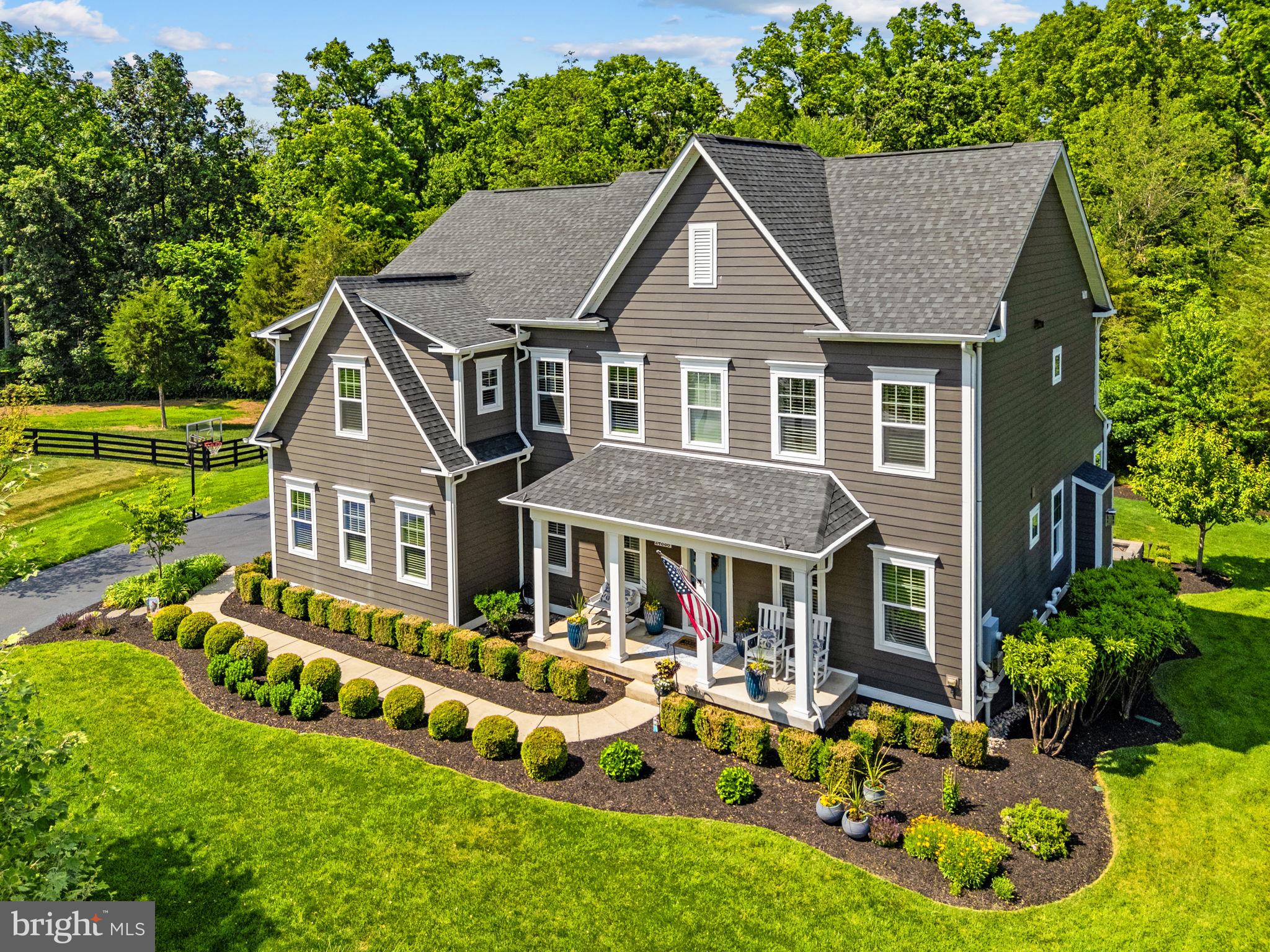 Experience elevated luxury living in the prestigious Greens at Willowsford, where timeless elegance, refined craftsmanship, and resort-style amenities come together to create an unparalleled lifestyle. Perfectly positioned on a rare cul-du-sac lot and expansive nearly one-acre homesite, this exceptional residence offers over 4,500 square feet of beautifully designed living space with sophisticated finishes and thoughtfully curated indoor and outdoor entertaining areas.
 

A grand entrance welcomes you into an open and light-filled floorplan featuring soaring ceilings, wide-plank hardwood flooring, designer lighting, elegant moldings, and expansive gathering spaces designed for both everyday living and upscale entertaining. The gourmet chef’s kitchen serves as the heart of the home, showcasing premium cabinetry, an oversized center island, granite countertops, stainless steel appliances, a spacious walk-in pantry, and seamless flow into the impressive family room with a cozy fireplace and walls of windows overlooking the private backyard retreat.

 

The upper level offers a luxurious owner’s suite designed as a true sanctuary, complete with spa-inspired bath, dual vanities, oversized glass shower with two shower heads, and generous walk-in closets. Spacious secondary bedrooms with brand new carpets, beautifully appointed baths, and versatile flex spaces provide exceptional comfort and functionality for modern living.

 

The fully finished lower level is ideal for entertaining and relaxation, featuring expansive recreation spaces, a custom wet bar, guest accommodations, abundant storage, and endless possibilities for a home theater, fitness studio, or golf simulator.

 

Outside, enjoy the serenity and privacy of the oversized estate-style homesite with ample room for outdoor living, future pool potential, and unforgettable gatherings under the stars. A spacious three-car garage and professionally designed exterior complete this remarkable offering.

 

Located within the award-winning Willowsford community, residents enjoy an unmatched lifestyle surrounded by over 2,000 acres of preserved open space, scenic countryside, tranquil ponds, and more than 40 miles of walking and biking trails. Exceptional community amenities include resort-style pools, state-of-the-art fitness center, community clubhouse, lakeside lodge, boating and fishing on Willow Lake, dog parks, sledding hill, amphitheater, playgrounds, outdoor gathering spaces, community events, and the renowned Willowsford Farm featuring farm-to-table experiences, farmers markets, and culinary events. Ideally situated near top-rated Loudoun County schools, major commuter routes, wineries, dining, and shopping, this extraordinary home offers the perfect balance of luxury, convenience, and natural beauty