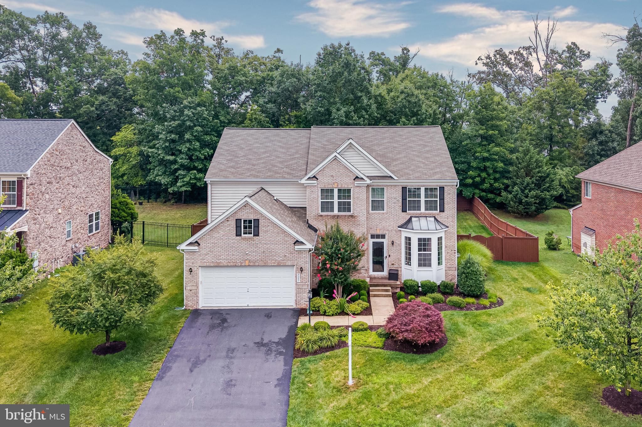 Welcome Home to this exceptional 4-bedroom 2.5 bath brick Colonial in the coveted Regents at Lake Manassas, showcasing stately architecture, expansive living spaces, and a lifestyle of comfort and sophistication. This home has been beautifully landscaped, meticulously maintained and well loved.

From the moment you enter, you'll be impressed by the hardwood floors, upgraded finishes, and abundant natural light throughout. The gourmet kitchen is a chef's dream, featuring an oversized center island, granite countertops, stainless steel appliances, double wall ovens, a five-burner induction cooktop, and extensive cabinetry for exceptional storage and functionality. The kitchen also features a large dining area.

The spacious family and gathering areas flow seamlessly, creating an inviting atmosphere for hosting family and friends. Upstairs, generously sized bedrooms provide comfortable retreats, while the luxurious primary suite offers the perfect place to unwind.

Step outside to a private, fenced backyard backing to mature trees. Stunning patio with fire pit perfect for outdoor entertaining.

Ideally located within the prestigious Lake Manassas community, residents enjoy convenient access to shopping, dining, golf, major commuter routes, and top-rated schools. Combining timeless architecture, premium upgrades, and an exceptional location, this remarkable home presents a rare opportunity to experience  Northern Virginia living at its finest.

This home has an assumable VA loan.