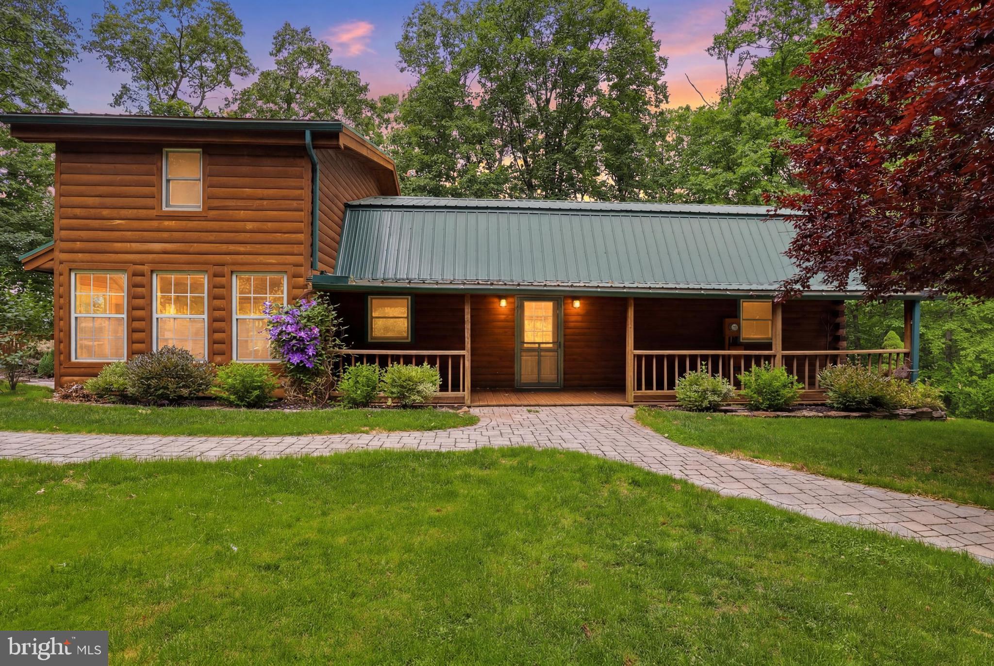 Escape to your own private retreat with this stunning log cabin-style home nestled over 3 acres in Red Lion, 1.58 acres plus additional 2 acres of woods all surrounded by trees and nature. This property offers the perfect blend of privacy, comfort and outdoor living. Featuring 5 bedrooms with one of the bedrooms being in the loft area and another in the possible in-law quarters and 3 big bathrooms, this home has room for everyone. Inside, you will find hardwood floors, new carpet, cedar closet.  Florida room perfect for enjoying peaceful surroundings year-round. The versatile layout potential for in-law quarters or additional living space. Outside the amenities continue with a large pole building/garage offering ample space for vehicles, hobbies, or equipment or recreational activities. Dog lovers will appreciate the large dog run. With an acre of underground invisible fence. Spend summer relaxing by the pool that stretches 18 feet around the deck. This one-of-a--kind home truly has everything you been looking for -privacy, space and character for all your favorite things. Schedule your showing today.