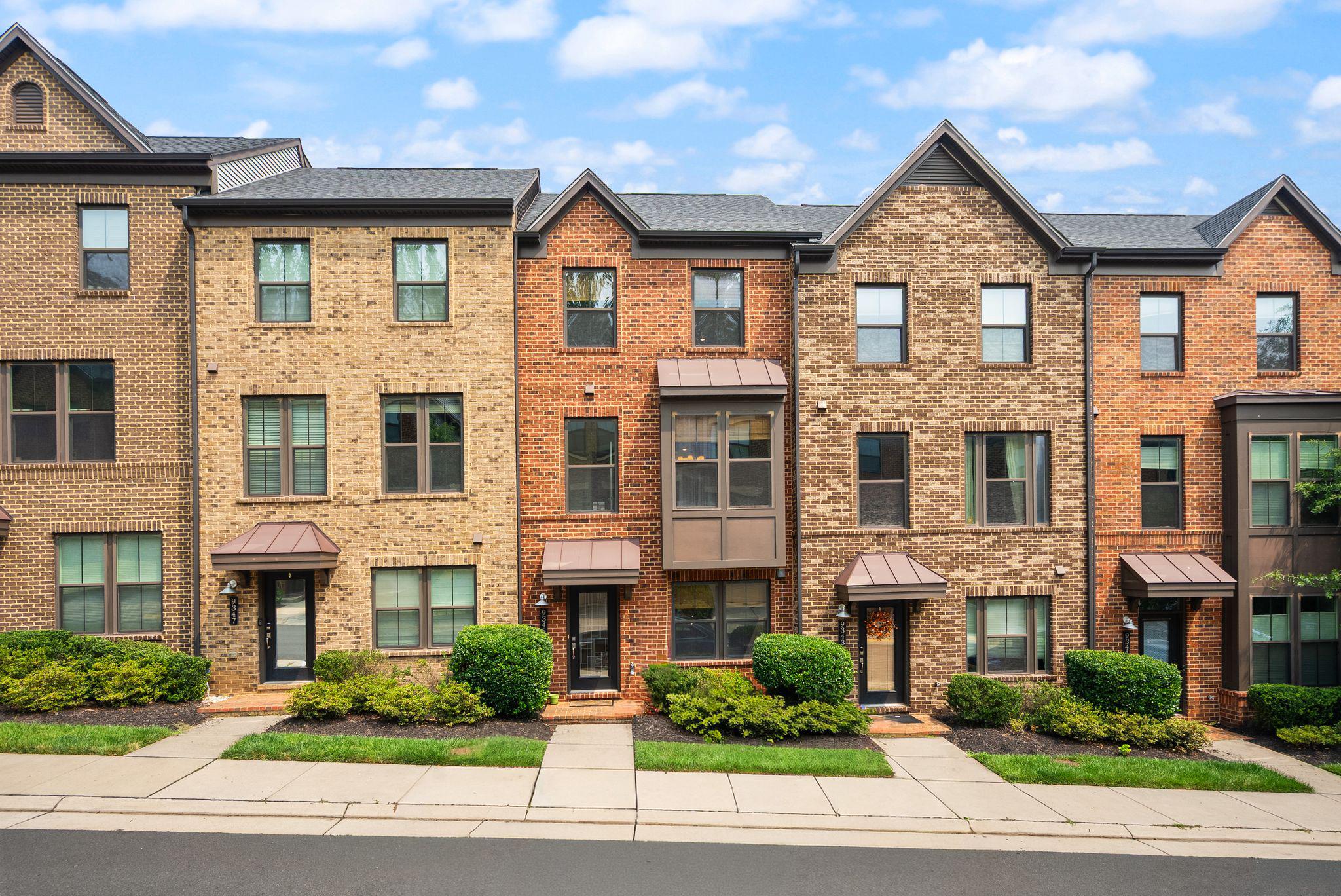 **OPEN HOUSES: Sat 7/25 11-1 and Sun 7/26 12-2** Built by NVHomes in 2018, this MetroRow townhome offers 3 bedrooms, 3 full bathrooms, 1 half bathroom, a flexible recreation room, and a large rear-entry 2-car garage. New carpet is installed throughout, and the interior was freshly painted in fall 2025.
Espresso-toned engineered hardwood flooring runs throughout the main level which is an entirely open floor plan. The center kitchen features an oversized island, beautiful quartz countertops, stainless steel appliances, a gas cooktop with exhaust hood, built-in microwave, wall oven, and subway tile backsplash. This is a practical layout for everyday living and entertaining.
A covered SkyLanai with a fireplace extends the main living space outdoors and features a gas fireplace. This space is perfect for outdoor dining, conversation areas, game-day gatherings, and year-round entertaining without the maintenance of a traditional yard or exposed rooftop terrace.
The upper level includes two bedroom suites and the laundry area along with an oversized landing. The primary bedroom features two walk-in closets with professional organization systems and an en-suite bathroom with dual vanities and a large walk-in shower with a built-in bench and on-trend ceramic tiles. The second bedroom has private access to the hall bathroom.
The ground-level bedroom also has private access to a full bathroom and currently serves as a home office. The adjoining recreation room is well suited for a movie room, fitness area, playroom, or hobby space.
The $90 monthly HOA fee includes common-area maintenance, lawn maintenance, trash, and recycling. Located approximately one mile from the Vienna Metro, Route 66 entrance, and HOV lanes, with convenient access to Mosaic District, Tysons Corner, Fairfax City, shopping, dining, and major commuter routes. Currently zoned for Marshall Road Elementary School, Thoreau Middle School, and Oakton High School.