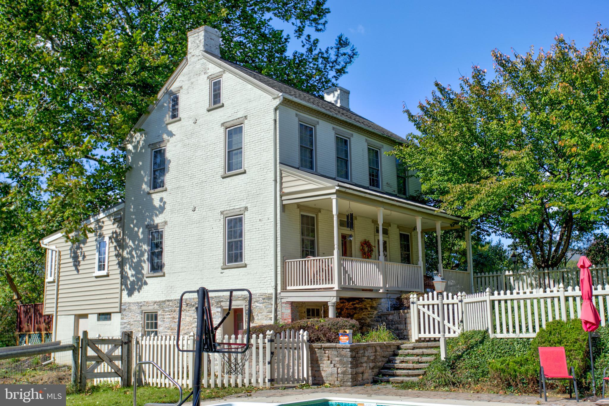Enjoy the pleasure of owning a 3.7 acre farmette in Lititz! This home features a beautiful tree lined driveway, which opens up to a circular driveway and secluded home with updated 1880 farmhouse. The home features 4BR, 2.5 BA, which includes a first floor master bedroom and bath and walk in closet. Walk into the open floor plan kitchen which has large windows opening up to the backyard and views of the pond. The large island in the kitchen has a lot of space for entertaining or meal preparation. Many original features with hardwood floors, old hardware, and deep window sills. Many updated features with replacement windows, central air, and zoned heating. The first floor has laundry room, half bath, 2 fireplaces, and 2 living rooms. The upstairs has 3 bedrooms and  full bath. Large 2 story barn, and detached 3 car garage. Exterior of the home, has lots of room to enjoy open space in the yard, and in-ground swimming pool, and a pond. Come and visit this spectacular home in Lititz and create years of many memories. Schedule your showing today!