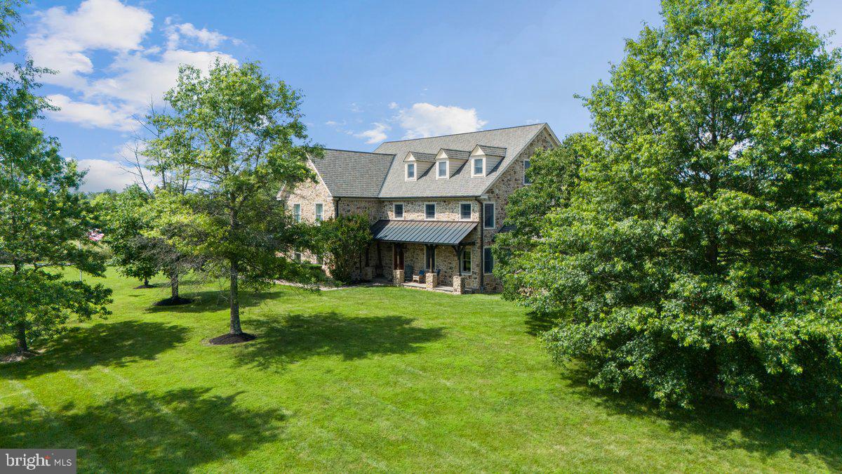 .Privately set on 33.8 acres of open fields and tree-lined boundaries, this custom 6,200+ square foot stone residence—constructed entirely in stone—offers a rare balance of privacy, scale, and accessibility, just over an hour from New York City.

Designed for both everyday living and extended stays, the home features a flexible, gracious layout well-suited for multi-generational living, guest accommodations, or a refined weekend retreat. Radiant heated floors, Brazilian hardwood flooring, and generous room sizes reflect quality craftsmanship throughout, while the home is comfortably livable as-is with the opportunity to tailor interiors over time to suit a more personalized aesthetic. ALSO See MLS: PABU2115562

Positioned to one side of the property, the residence allows the surrounding acreage to truly shine—offering exceptional flexibility for a pool, equestrian pursuits, gardens, or the potential for a guest residence, subject to township approvals. The property directly borders High Rocks State Park, enhancing both privacy and the natural beauty of the setting.

Ideally located near Doylestown and New Hope, with easy access to Philadelphia, Princeton, and New York City, this offering presents a rare opportunity to secure meaningful acreage, privacy, and flexibility—without sacrificing connection to the towns, amenities, and lifestyle that define Bucks County living.