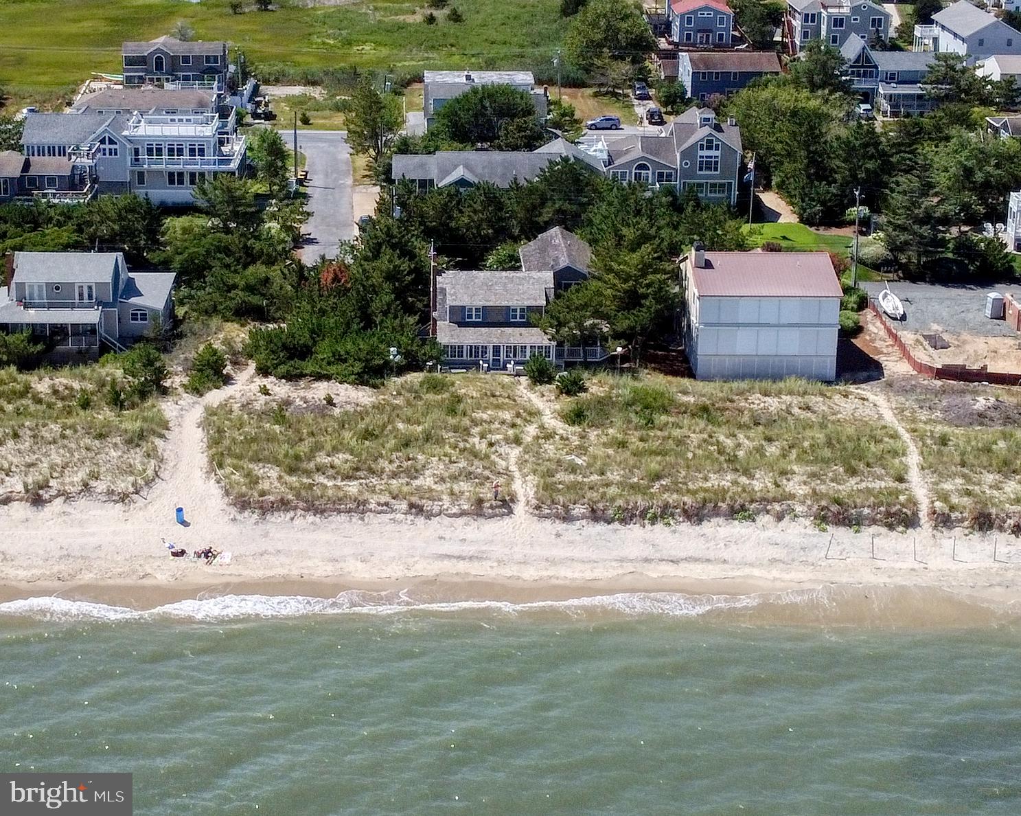 Extremely Rare Bay Front home on Lewes Beach!!!    Built in 1939 with major remodel and addition completed by Coffin Builders in 2005-2006.  Situated on a large 75' x 100' lot, the home has nearly 4000 square feet of living space, a first floor master suite, 5 additional bedrooms on the 2nd floor, 3-zone heat and air conditioning, spacious kitchen, formal dining room, large family room with a wood burning fireplace, a front sunroom and a screened porch.   Direct beach and bay access from the sandy path on the bay side, front deck, outside shower, off-street parking, walkways, and mature landscaping,     The basement was expanded in the 2007 addition and constructed on pilings with interior access as well as Bay Ave egress doors for bikes and beach toys, 3 sump pumps, bike storage area, workshop and 3 play rooms.  The beach out front offers low tide sandbars and direct water access for paddle boards, kayaks, sunfish. surf fishing, beach combing and superb  Lewes Beach sunrises and sunsets.  A short 2-block walk to the Roosevelt Inlet, bike into town or pick up the expanding bike trails' network.    Cape Henlopen State Park offers; drive-on vehicle beach access, surfing, camping, WWII museum, bunkers and towers and  Gordon's Pond .