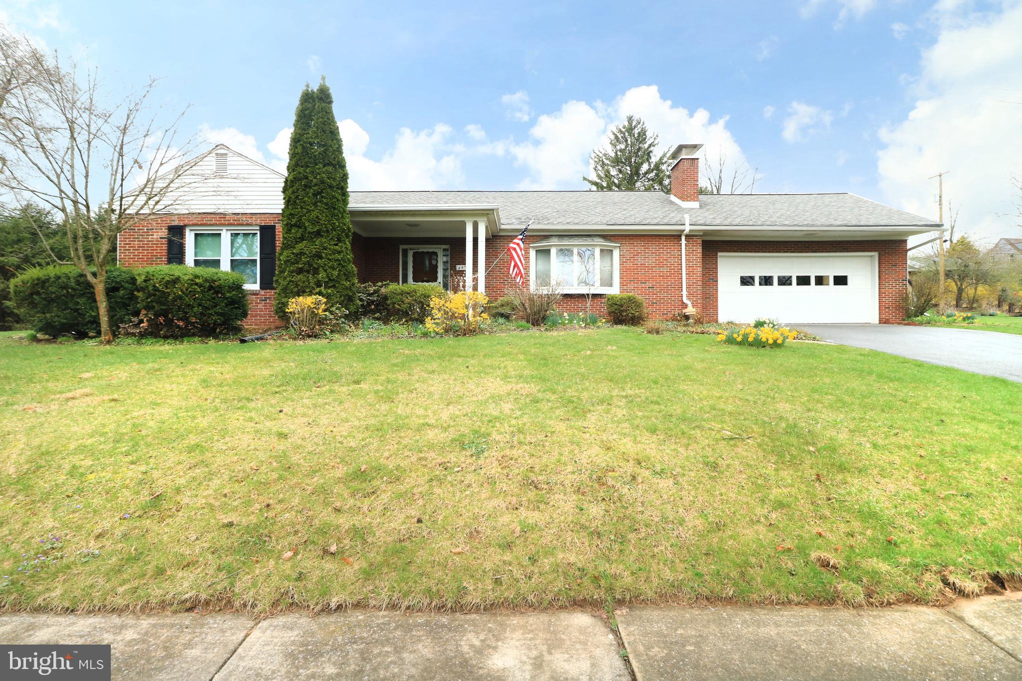 Discover the charm of State College Borough along tree-lined streets in a welcoming, well-established neighborhood. Nestled in the Highlands on serene E McCormick Ave, this sturdy brick ranch warmly invites you to experience true one-level living.  Set on a generous 0.49-acre lot adorned with lush, mature landscaping & striking curb appeal, this move-in-ready home radiates care & character. Upon entering the bright foyer, you are greeted by a spacious living room featuring a cozy brick wood-burning fireplace, built-ins & a delightful bay window—a perfect setting for relaxation & memorable gatherings.  The darling dining room flows seamlessly into a fully equipped kitchen. Outfitted with included appliances, a tasteful tile backsplash & solid wood cabinetry, the kitchen is designed for creating culinary delights. Adjacent to the kitchen, the convenient main-floor laundry/mudroom features a washer, dryer, extra storage, entrance to the attached garage & a separate exterior entrance to the backyard.  Sunlight cascades throughout the home, particularly into the 21x9 sun-kissed sunroom.  Featuring ceramic tile flooring & serene views of the peaceful backyard, this sun-drenched retreat offers an ideal space for relaxation or a casual work-from-home setup. A large rear deck off the sunroom provides the perfect venue for entertaining guests during Happy Valley weekend events.  Retreat to the private owner’s suite, complete with a personal full bathroom featuring a walk-in tile shower. 2 additional bedrooms & a second full bathroom offer comfortable accommodations for family members or visiting guests. Completing the package is a spacious unfinished basement for extra storage & an attached two-car garage, ensuring that practicality meets charm.  Located just moments from the vibrant energy of downtown State College & the excitement of Penn State University, this residence is perfectly positioned for both quiet living & an active lifestyle.