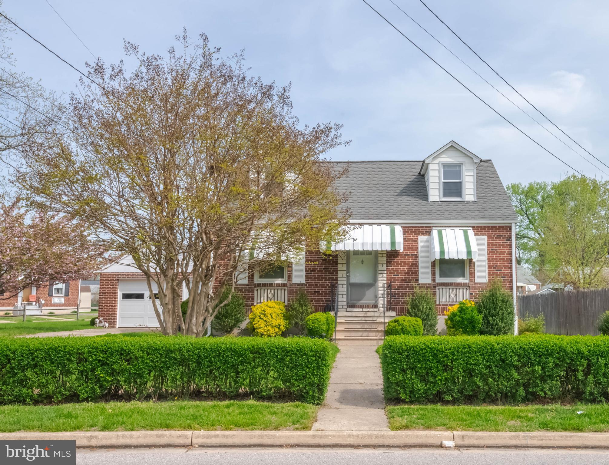 Charming 3-bedroom brick Cape Cod situated on a spacious double corner lot featuring a 2-car garage perfect for the car enthusiast. The first floor offers a kitchen, living room, two bedrooms, and a full bathroom, along with beautiful refinished hardwood floors, while the upper level includes a generously sized bedroom with abundant storage space. The finished lower level provides a comfortable family room, a large laundry area, and additional space ideal for storage or a workshop. This home also features updated windows and furnace, as well as fresh paint throughout. The corner lot is enhanced by beautiful mature trees and offers plenty of room for outdoor entertaining. Additional .08 lot included.