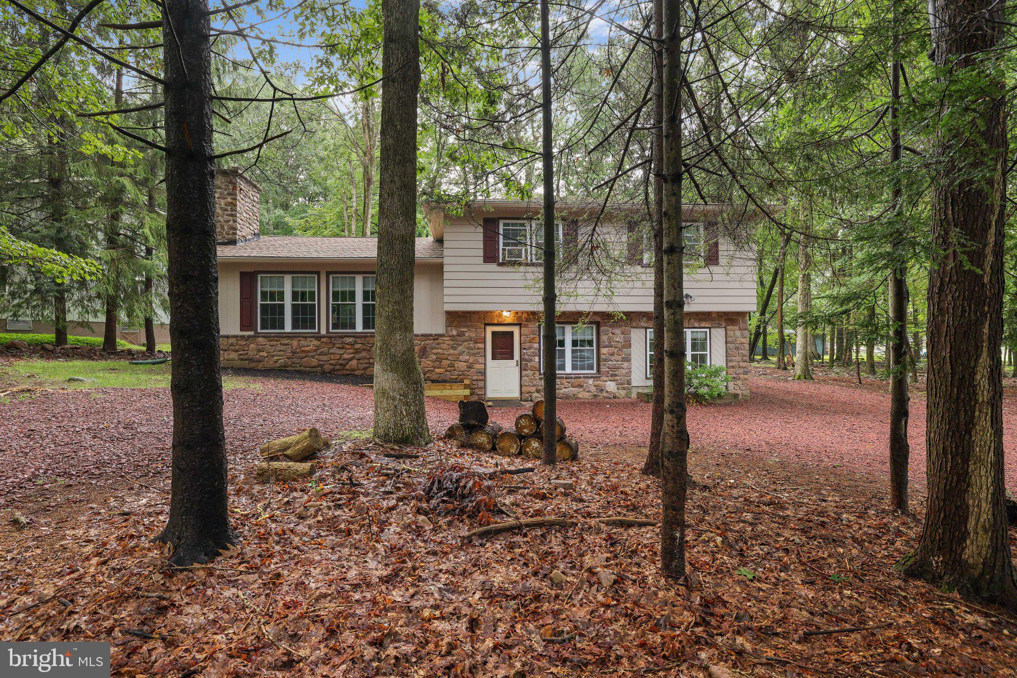 Your four-season Lake Harmony getaway awaits! This updated, fully furnished 4-bedroom, 2.5-bath home in the Split Rock area is ready for you to simply bring your bags and enjoy. Set on a lovely wooded lot, it offers an open-concept living, kitchen, and dining area, plus a lower-level rec room with pool table--perfect for entertaining. Relax outside on the patio with a firepit and hot tub, and enjoy the convenience of an EV charger. With the beach, lake, tennis, golf, hiking, and skiing nearby, there's something to enjoy year-round. Currently used as a vacation rental. Brand new hot tub being installed!