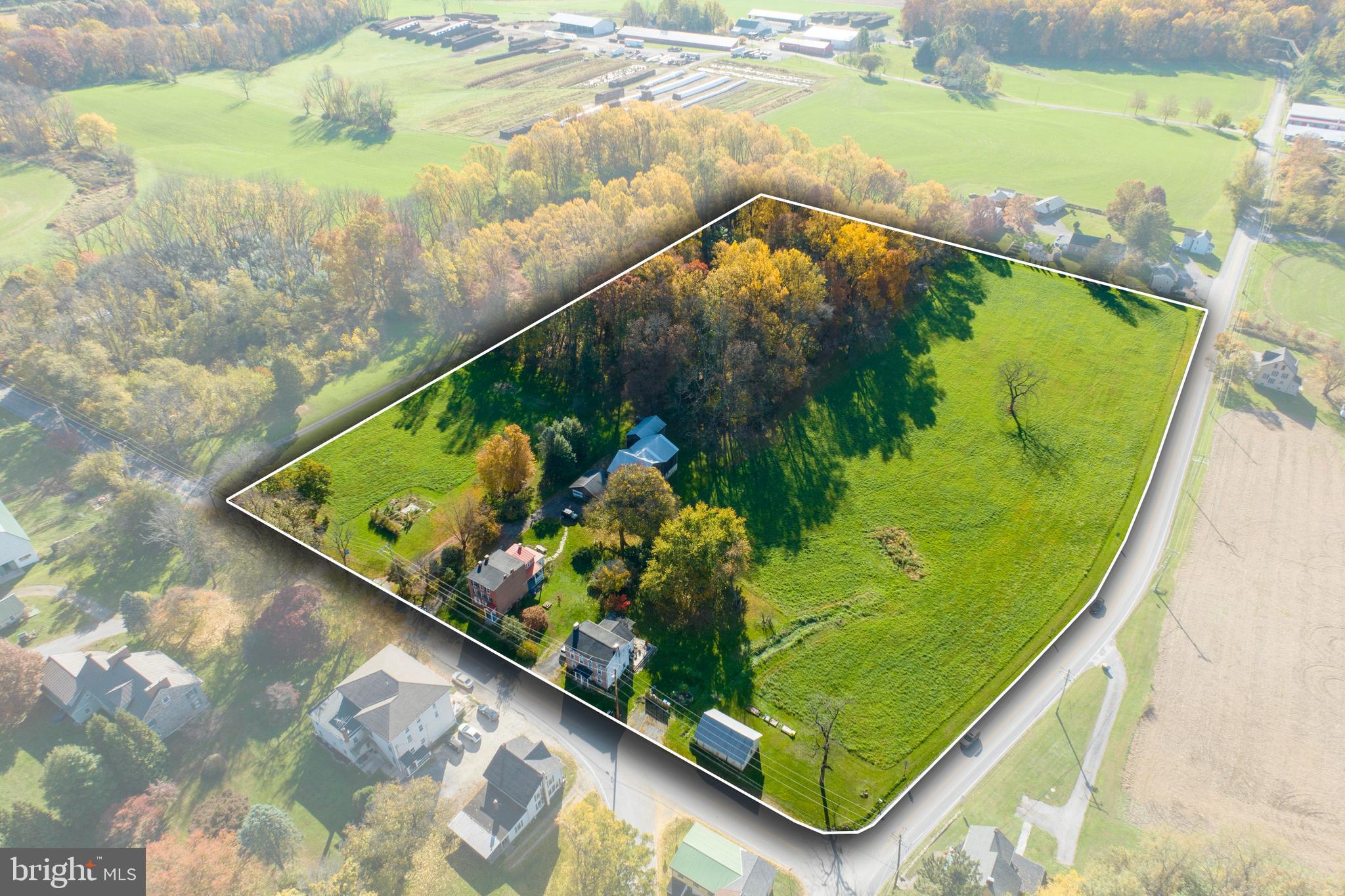 Nestled within the pastoral charm of London Grove Village in West Marlborough Township, this 11.7± acre historic estate offers a once-in-a-lifetime opportunity to create something extraordinary. Zoned as Village Residential and located within the prestigious Unionville-Chadds Ford School District—ranked among the best in Pennsylvania—this property is a rare find, offering the potential to subdivide into five spacious 2-acre lots (pending township approvals). With land for development in this highly sought-after area becoming increasingly scarce, this is your chance to shape a legacy.

The centerpiece of the property is a stately circa-1830 Federal-style brick home, brimming with history and character. From its original wide-plank floors and spiral staircase to its timeless marble exterior window sills and exposed beams, every detail tells a story. The residence includes two bedrooms, three bathrooms, formal living and dining rooms, and a mudroom, seamlessly blending historic charm with modern upgrades like a reverse-osmosis water system, updated electric, and stainless appliances.

Adding to the property’s allure are two additional three-story rental units, each with three bedrooms, a full bath, kitchen, and living area—perfect for generating immediate income or accommodating guests, family, or future redevelopment. The estate is further enriched by a circa-1820 post-and-beam barn with updated electric, a three-bay garage, and sprawling pastures ideal for equestrian use or farming.

For developers, this property’s configuration, abundant road frontage, and zoning make it a standout. The ability to create five 2-acre estate lots offers an unparalleled opportunity to cater to buyers seeking privacy, luxury, and proximity to Kennett Square’s vibrant dining and cultural scene. With Clean & Green (Act 319) tax advantages already in place, the property is as practical as it is picturesque.

Whether you’re a developer, an investor, or someone looking for land to build your dream home with endless possibilities, this offering is as rare as the land itself. Don’t miss your chance to secure this exceptional piece of Chester County’s landscape—an opportunity that simply doesn’t come around often.